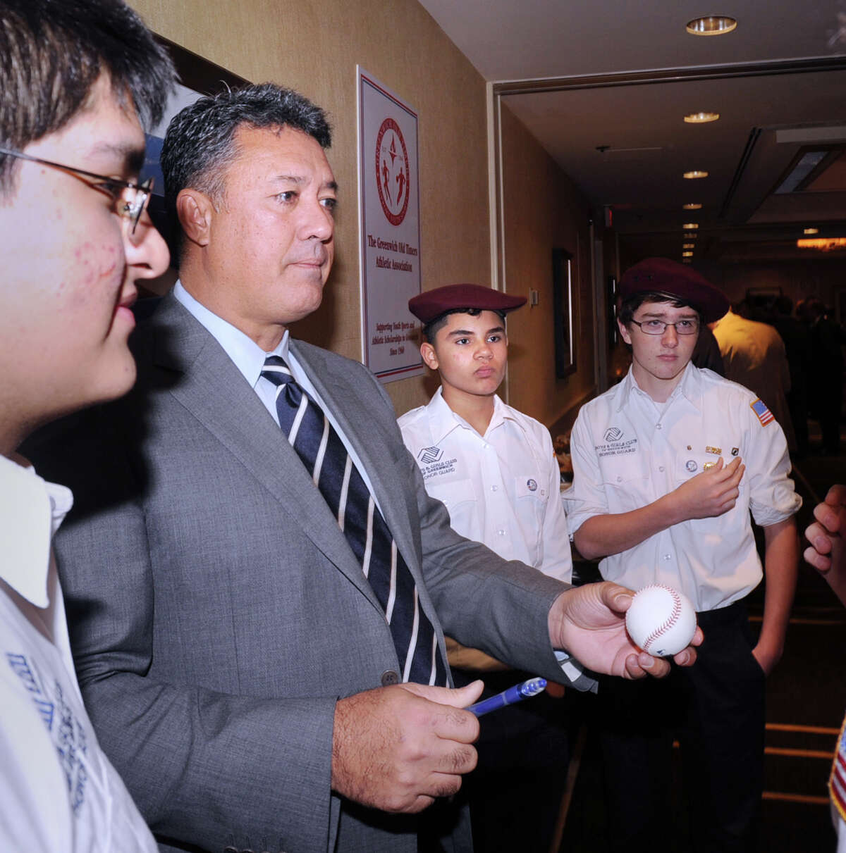 Former New York Mets pitching star Ron Darling, second from left, autographs a baseball during the 52nd Annual Greenwich Old Timers Awards Dinner at the Hyatt Regency Greenwich, Friday night, November 9, 2012. Standing from left to right, with Darling, are Greenwich Boys & Girls Club Honor Guard members, Victor Sanchez, 15, Emilio Rojas, 13, and Peter Hughes, 16. Darling was honored during the dinner.