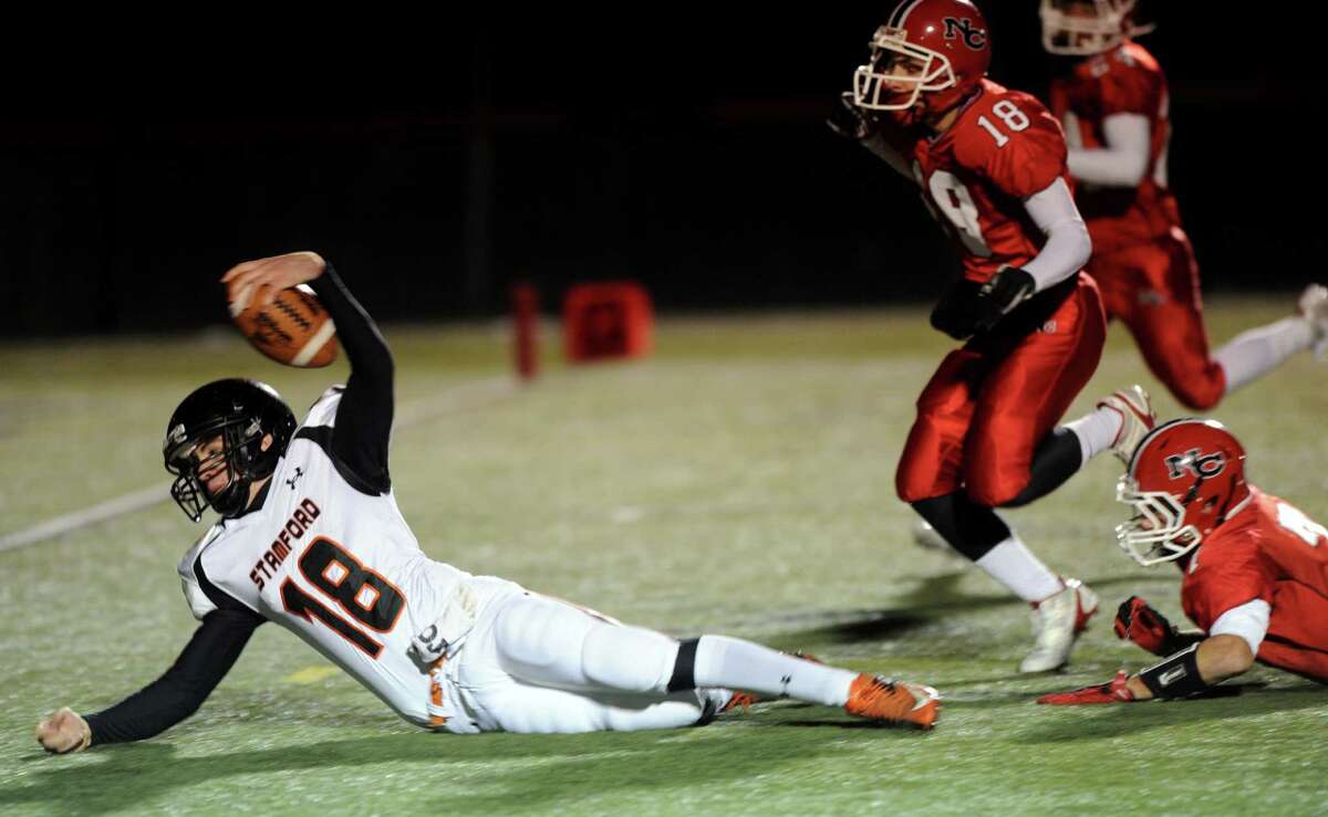 Stamford's Tyler Kane carries the ball as he attempts to reach for a touchdown but fell short during Friday's football game against Stamford at New Canaan High School on November 9, 2012.