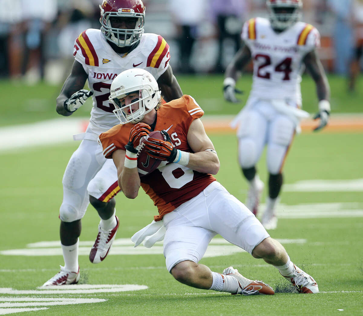 Texas' Jaxon Shipley makes one of his eight catches in front of Iowa State's C.J. Morgan.