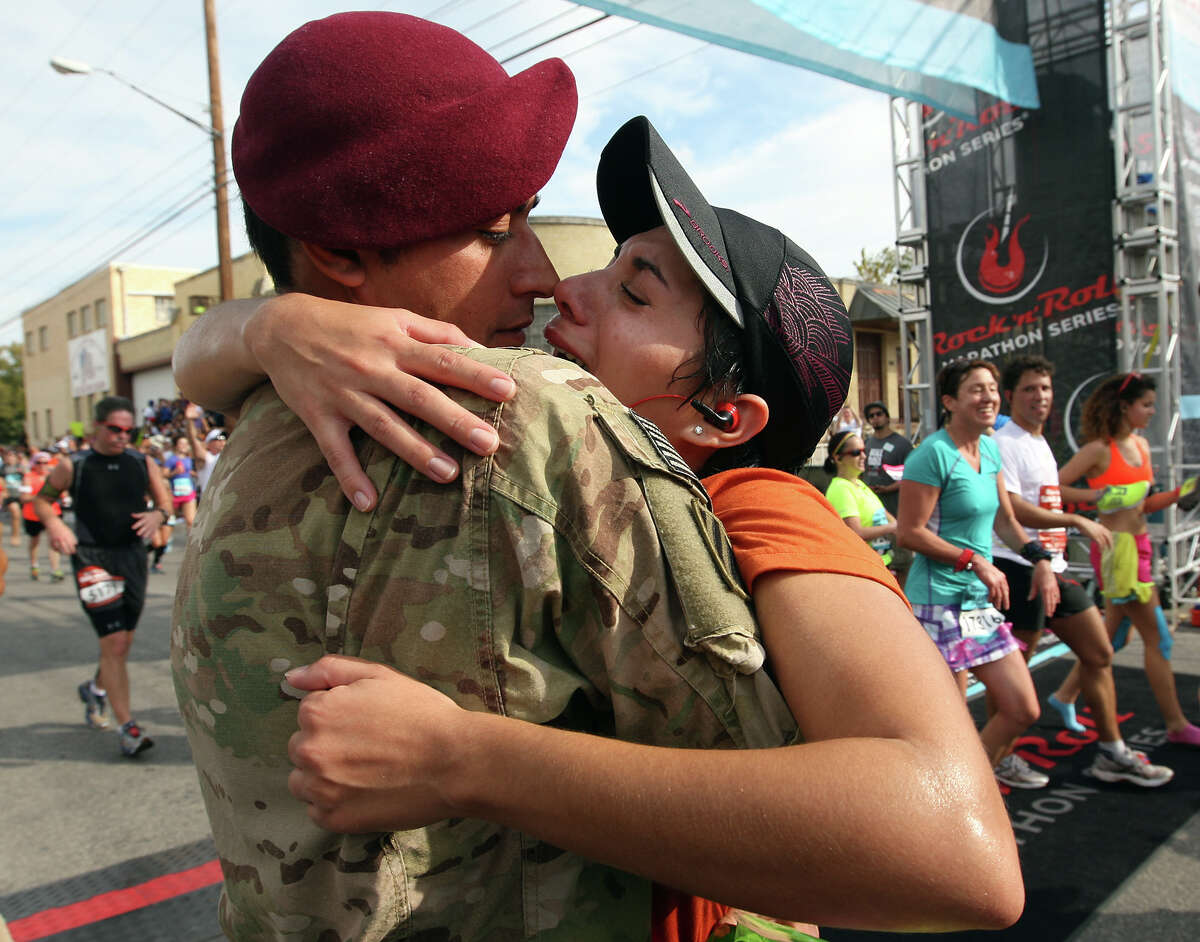 At the finish line, Sgt. Jonathan Gillis hugs his wife, Giselle, after she finished the half marathon in the Rock 'n' Roll San Antonio Marathon and 1/2 Marathon, Sunday, Nov. 11, 2012. Gilles, who was deployed to Afghanistan with the Texas Army National Guard, surprised his wife at the event. He arrived with his company to Camp Atterbury, Indiana last week but told his wife that his arrival would be delayed due to dental surgery.