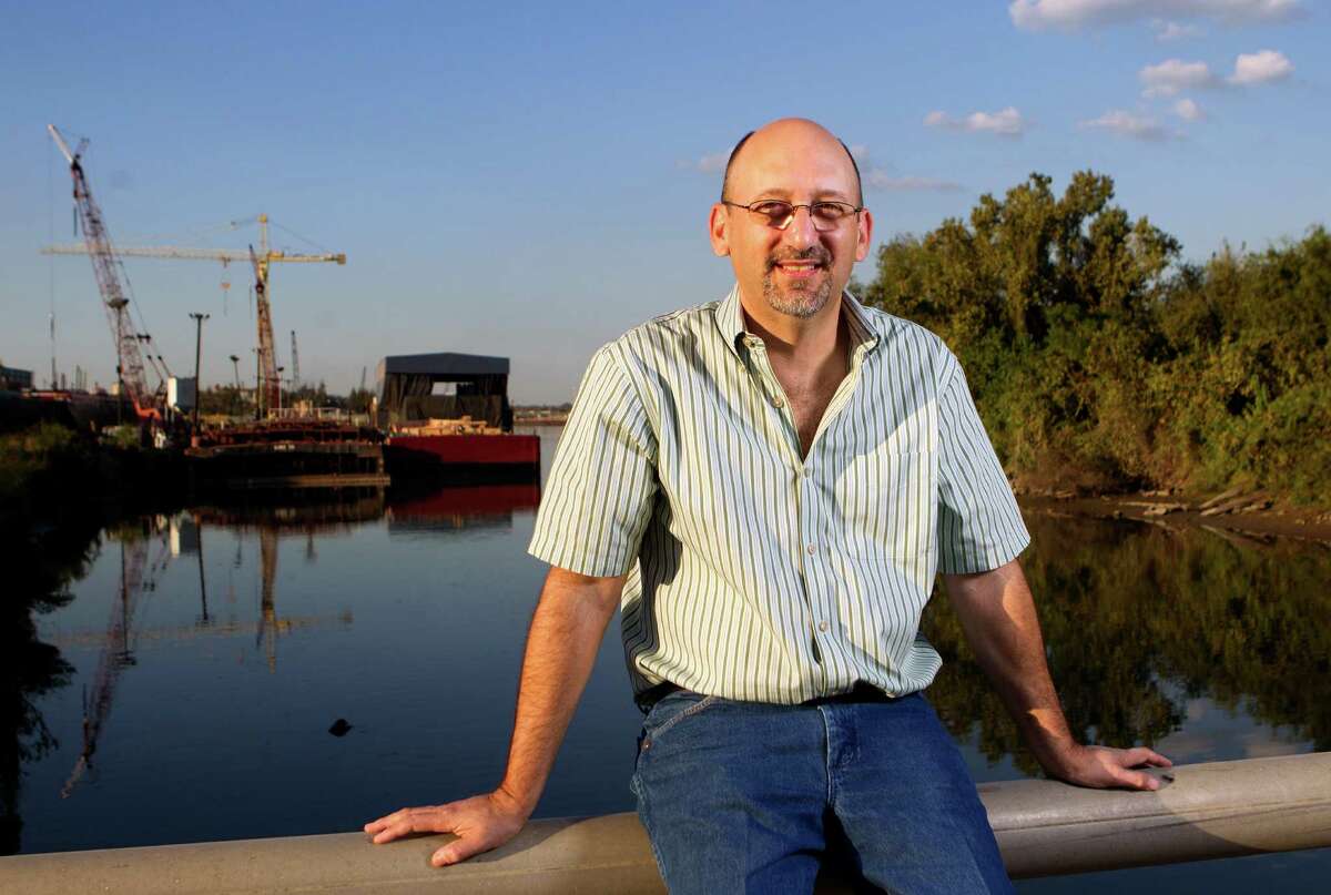 Alex Cuclis sits on a bridge overlooking the Houston Ship Channel where barges enter and exit Thursday, Nov. 1, 2012, in Houston. (Cody Duty / Houston Chronicle)