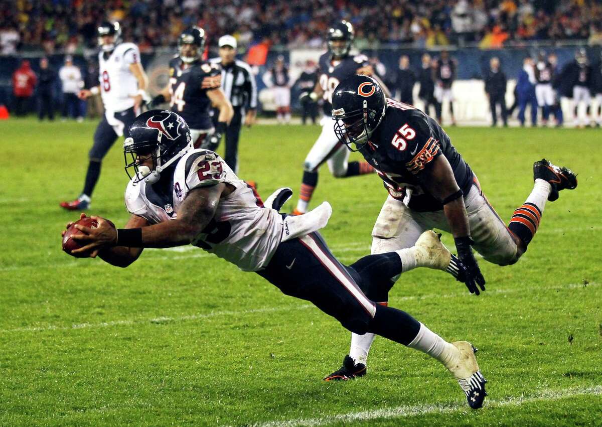 Houston Texans running back Arian Foster (23) makes a touchdown catch with Chicago Bears linebacker Lance Briggs (55) defending in the first half an NFL football game in Chicago, Sunday, Nov. 11, 2012. (AP Photo/Charles Rex Arbogast)