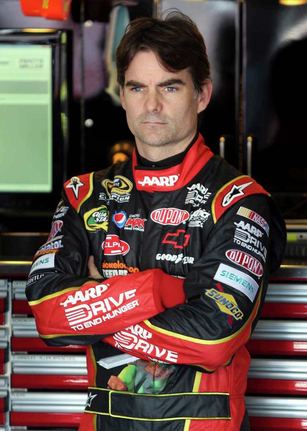 FILE - In this Oct. 12, 2012 file photo, Jeff Gordon waits before practice for the NASCAR Bank of America 500 Sprint Cup series auto race in Concord, N.C. NASCAR has a real dilemma on its hands with this whole Gordon mess hanging over the season finale, Sunday, Nov. 18, 2012 at Homestead-Miami Speedway. (AP Photo/Bob Jordan, File)
