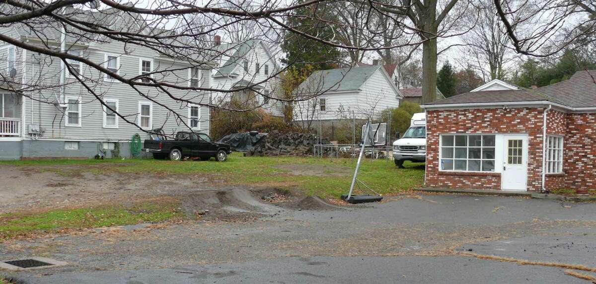 A developer wants to tear down the two-family house, to the left, and the brick building on the right to build a three-story building for both commerical and residential use. Fairfield, CT 11/13/12