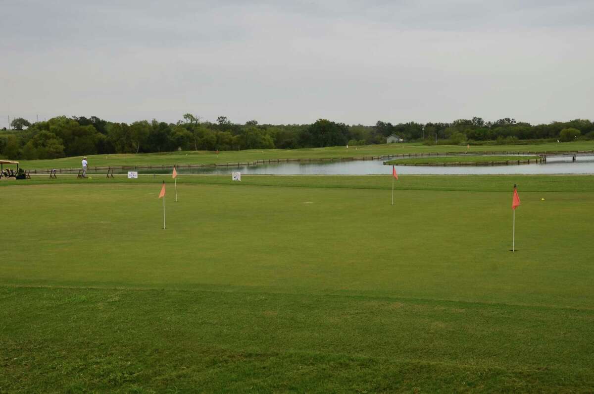 The River Bend Golf Club practice area includes a putting green, driving range and a target island for precision practice.