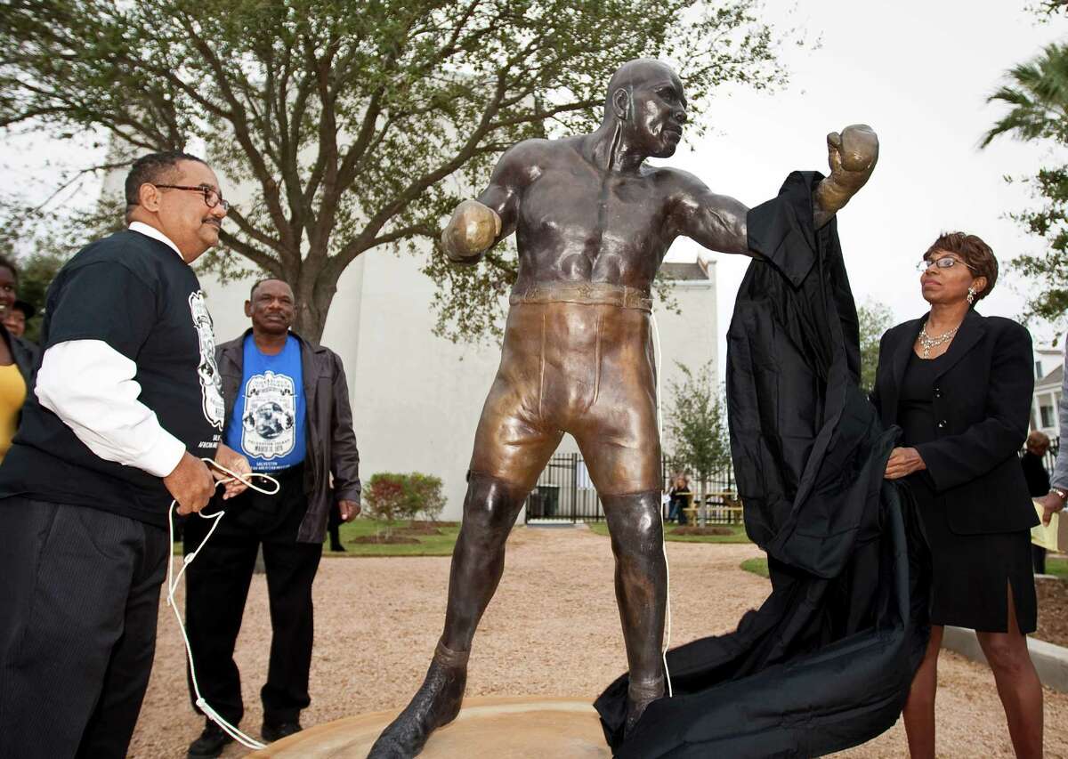 Adrienne Ison, an sculptress from Austin, unveils a statue she made of Jack Johnson during a dedication ceremony for Jack Johnson Park at the Old Central High School, Tuesday, in Galveston. Johnson was the first African American heavyweight champion.