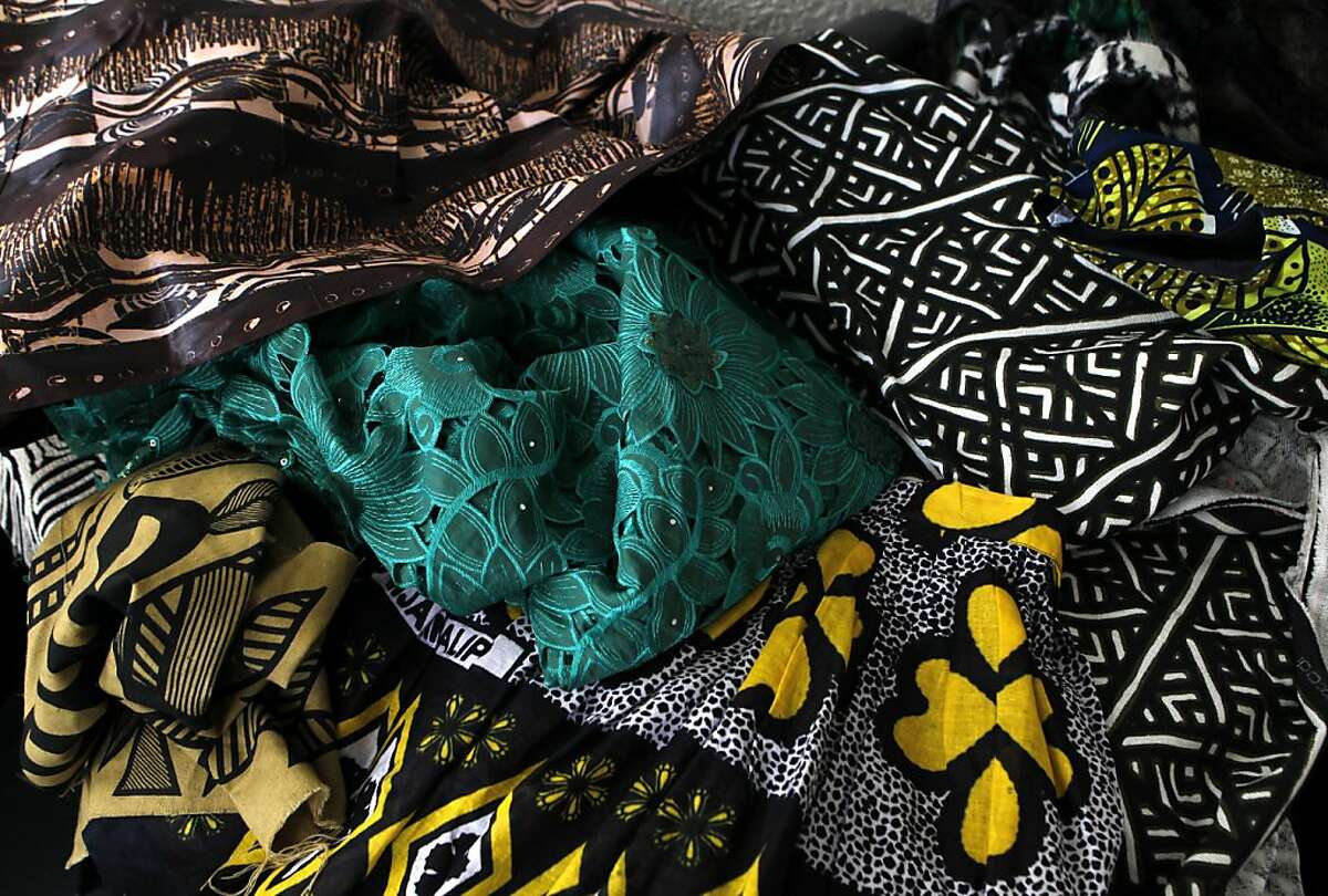 Fabrics used by fashion desginer Rebekah Lwanga Peterkin are spread out at her home studio in Oakland, Calif. on Tuesday, Nov. 13, 2012.