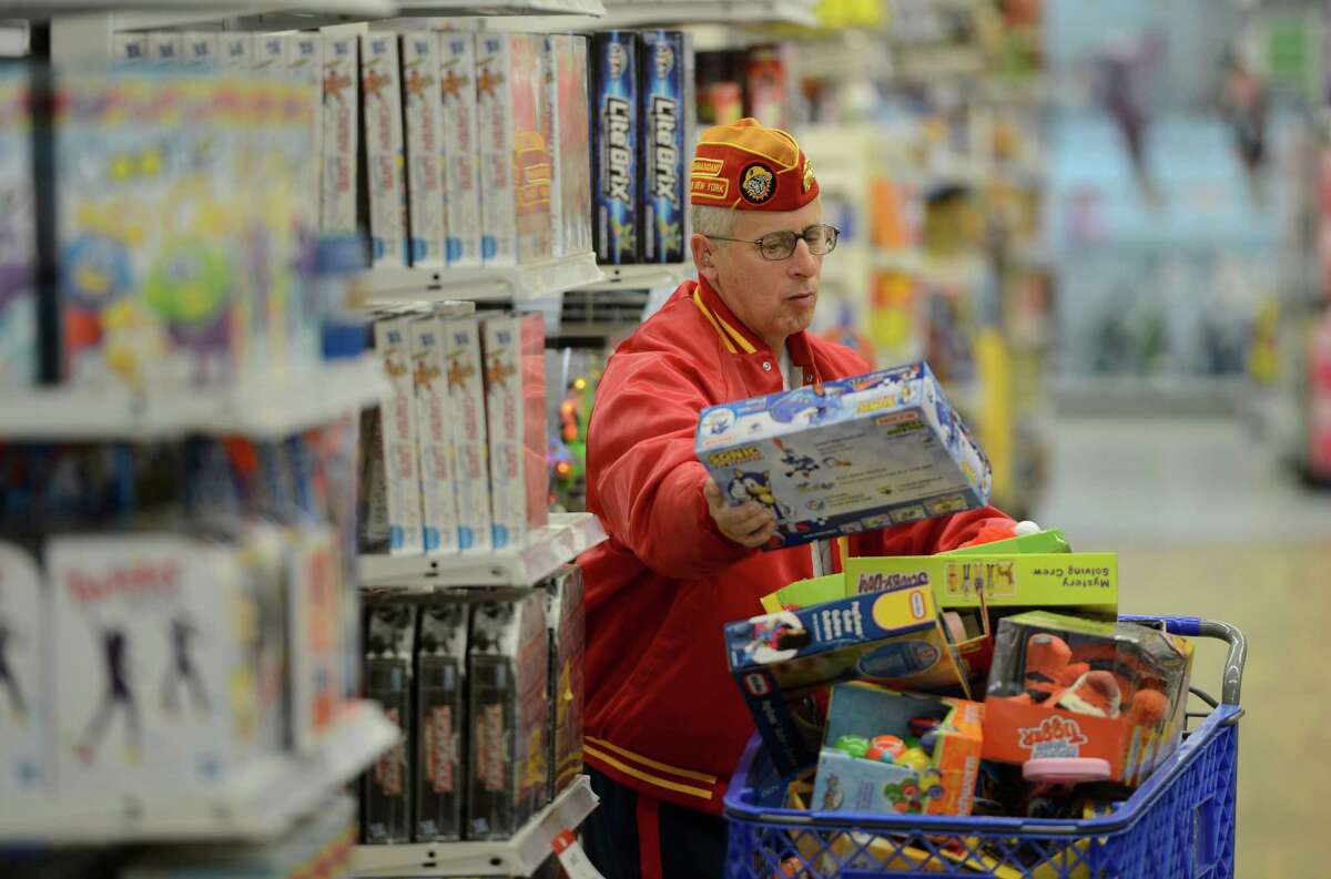 Marine Corps League member Tim Forbes searches for more toys at the Toys R Us store in Colonie, N.Y. for the "Toys for Tots" program Nov. 14, 2012. (Skip Dickstein/Times Union)