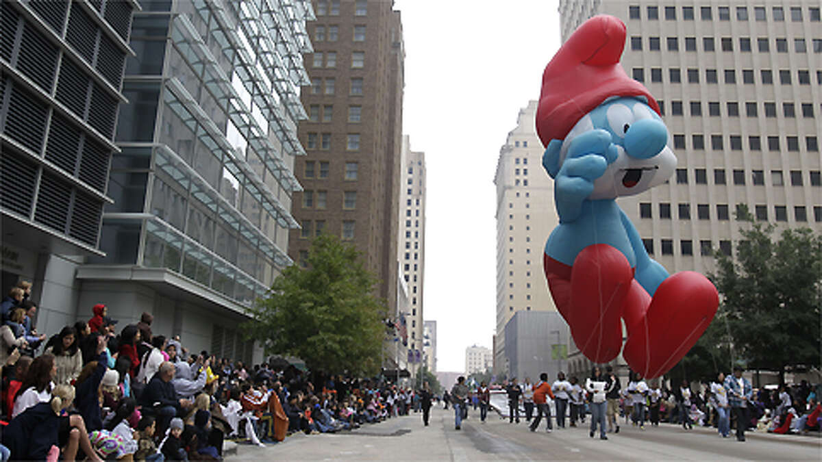 Smurf balloon floats down Fannin St. during the 62nd Annual Holiday Parade on Thanksgiving Day in downtown Houston Thursday, Nov. 24, 2011.