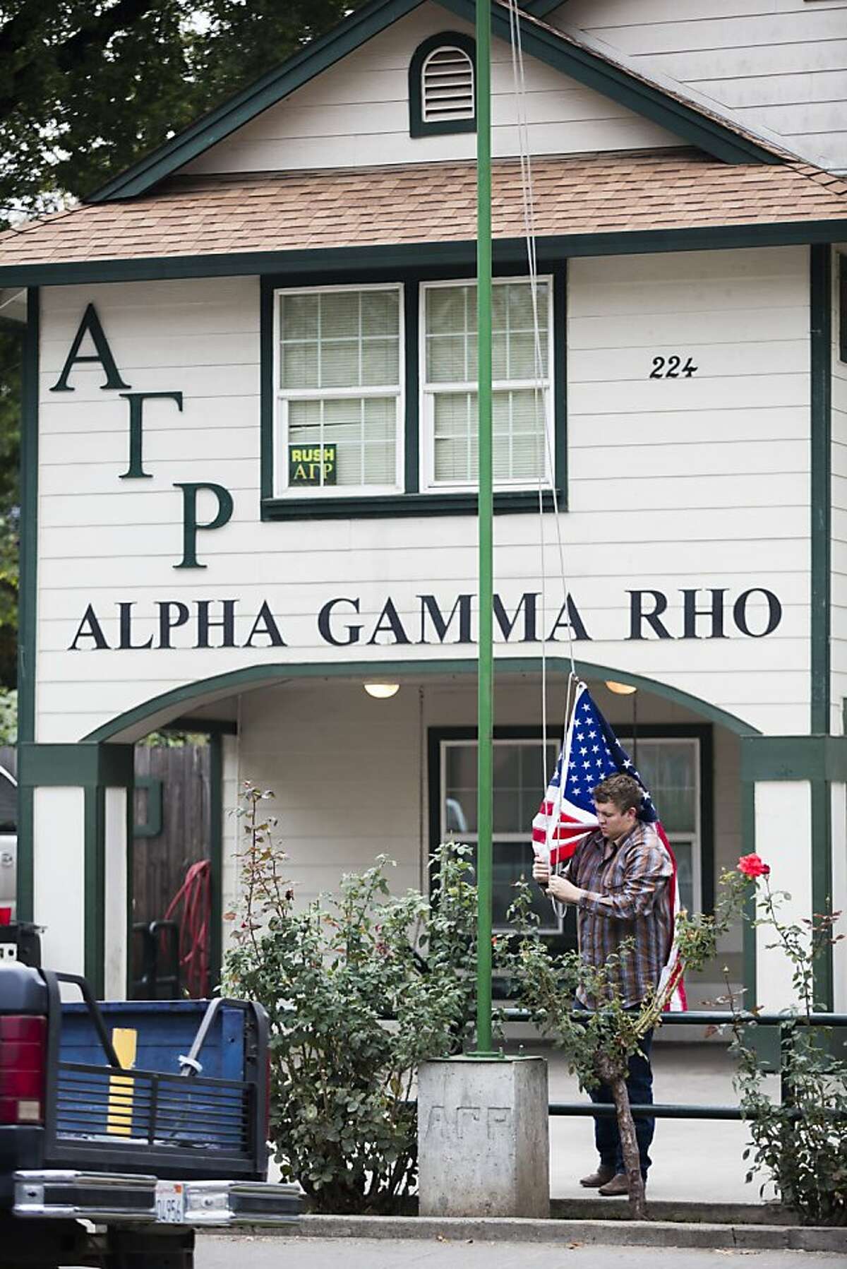 Fraternity Member rises the U.S. Flag at the Alpha Gamma RHO House, in Chico California, on Friday November 16th 2012 Chico State has suspended all its fraternities and sororities indefinitely after a series of unfortunate incidents, including the alcohol OD death of a student.