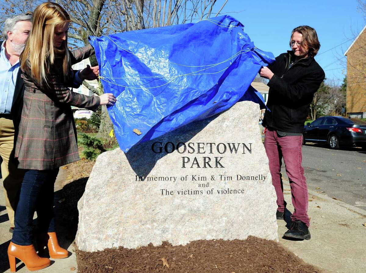 Tara and Eric Donnelly, daughter and son of Tim and Kim Donnelly, unveil the monument during a ceremony to dedicate Goosetown Park in memory of their parents and all victims of violence Saturday, Nov. 17, 2012 at the park in Bridgeport, Conn. Tim and Kim Donnelly were murdered during the robbery of their Fairfield jewelry store in February of 2005. Tim Donnelly grew up around the corner from the park and raised their family in the same neighborhood.