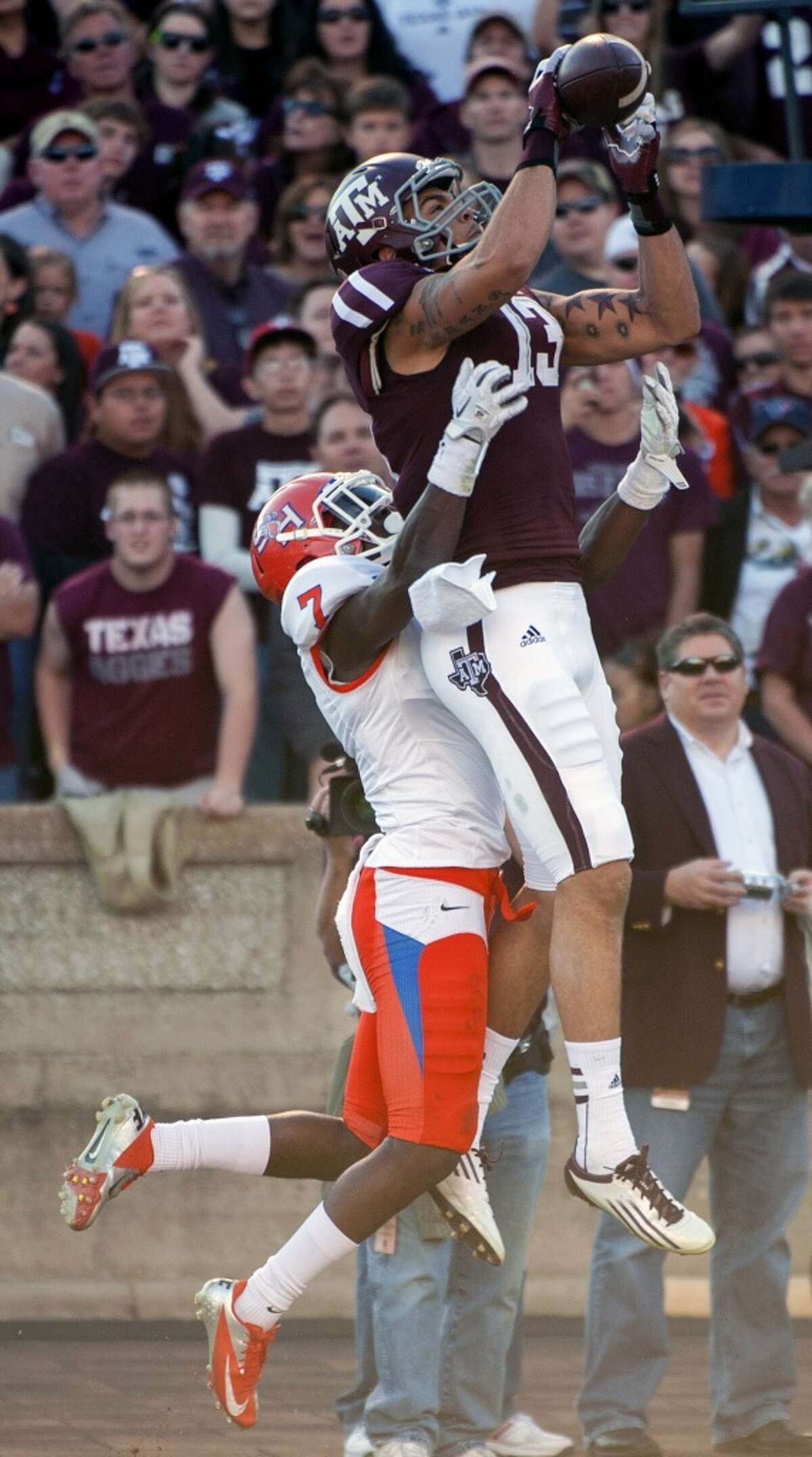 Texas A&M's Mike Evans (13) grabs a 13-yard touchdown pass over Sam Houston State's Dax Swanson (7) during the second quarter of an NCAA college football game, Saturday, Nov. 17, 2012, in College Station, Texas. (Dave Einsel / Associated Press)