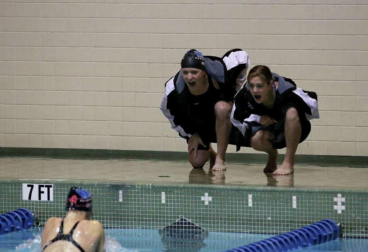 Mike Ross Connecticut Post freelance -Darien High School's Olivia Leunis receives cheering on from teammates Amanda Bieler and Becca Maroney during 200 IM heat during Saturday's State Open Championships at Yale University's Payne Whitney Gym.