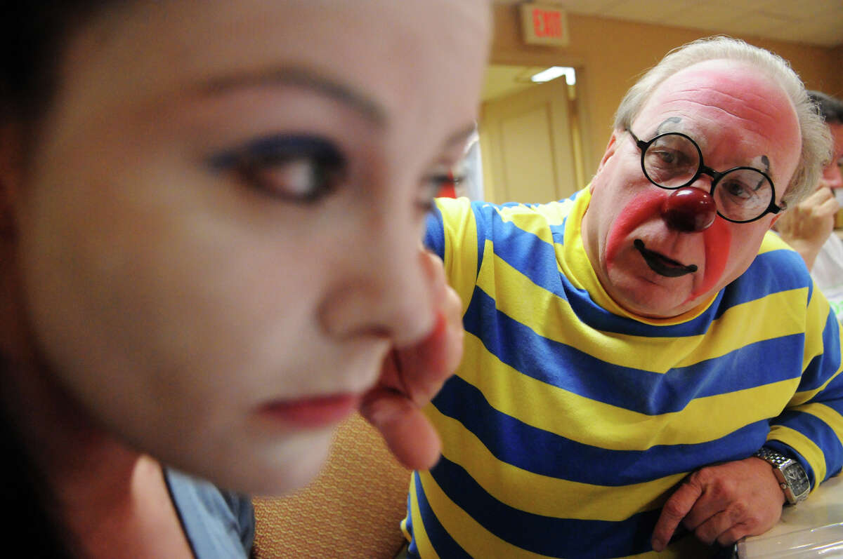 Professional clown Leo Desilets helps Advocate writer Maggie Gordon with her makeup during week two of clown college at the Stamford Marriott in Stamford, Conn., Nov. 14, 2012. Gordon will be a clown during the USB balloon parade Sunday.