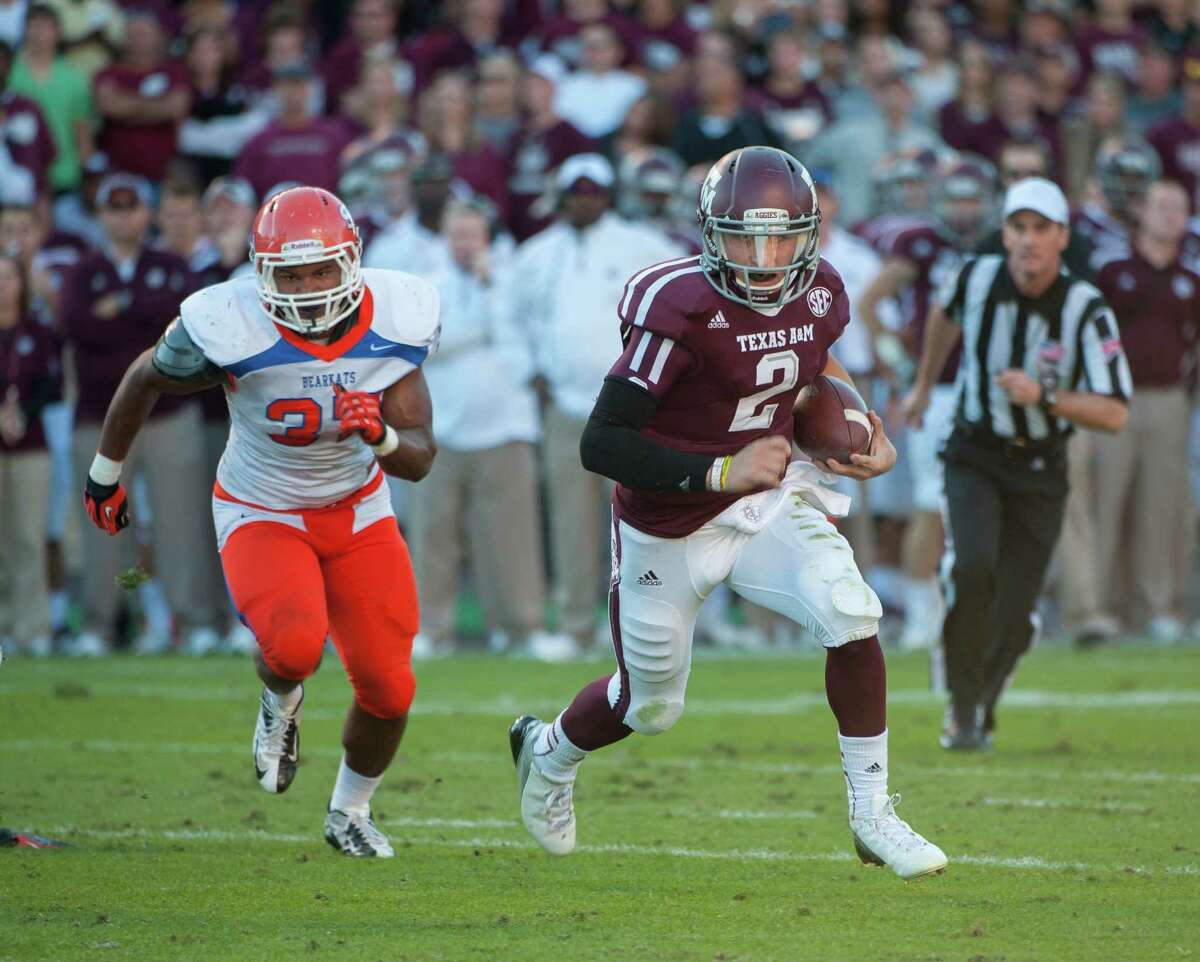 Texas A&M's Johnny Manziel (2) runs around Sam Houston State's Robert Shaw (23) for a touchdown during the second quarter of an NCAA college football game, Saturday, Nov. 17, 2012, in College Station, Texas. (AP Photo/Dave Einsel)