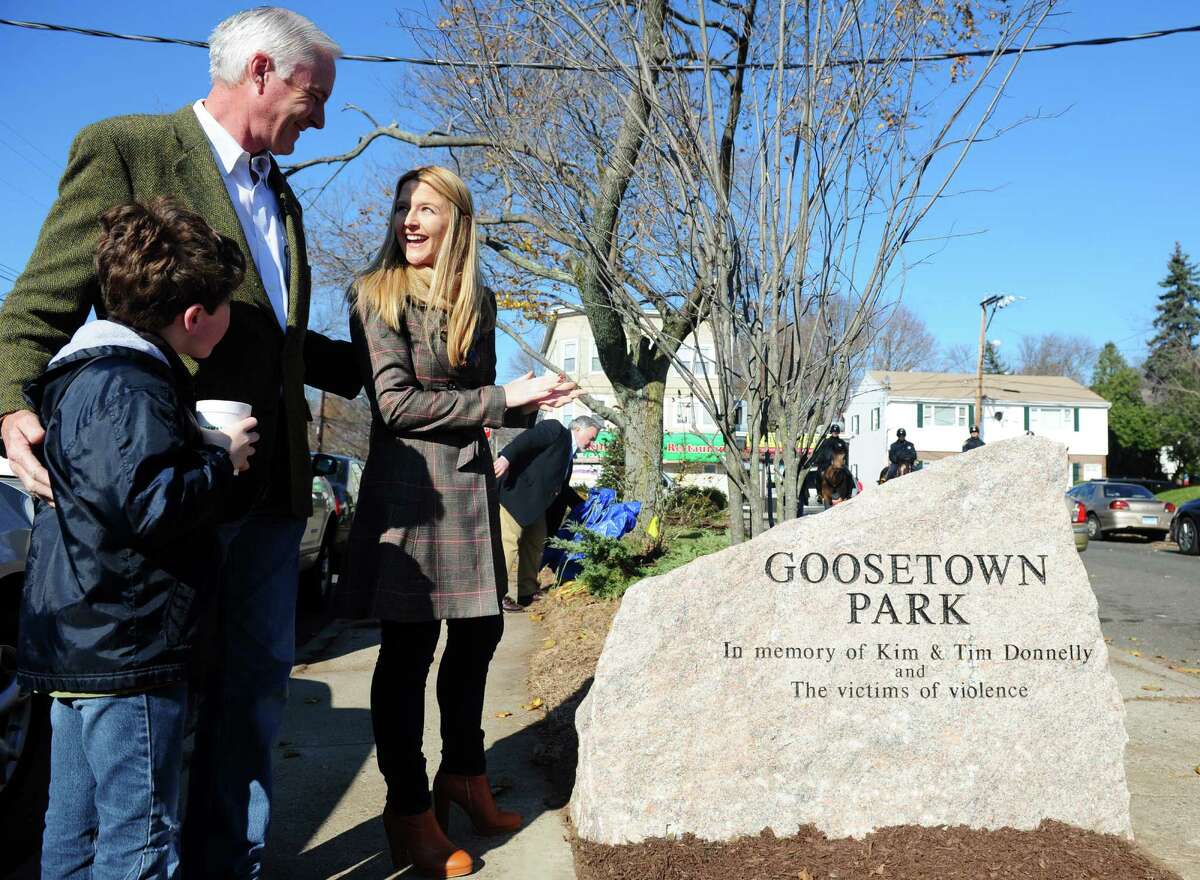 Mayor Bill Finch talks with Tara Donnelly, daughter of Tim and Kim Donnelly, during a ceremony to dedicate Goosetown Park in memory of her parents and all victims of violence Saturday, Nov. 17, 2012 at the park in Bridgeport, Conn. Tim and Kim Donnelly were murdered during the robbery of their Fairfield jewelry store in February of 2005. Tim Donnelly grew up around the corner from the park and raised his family in the same neighborhood.