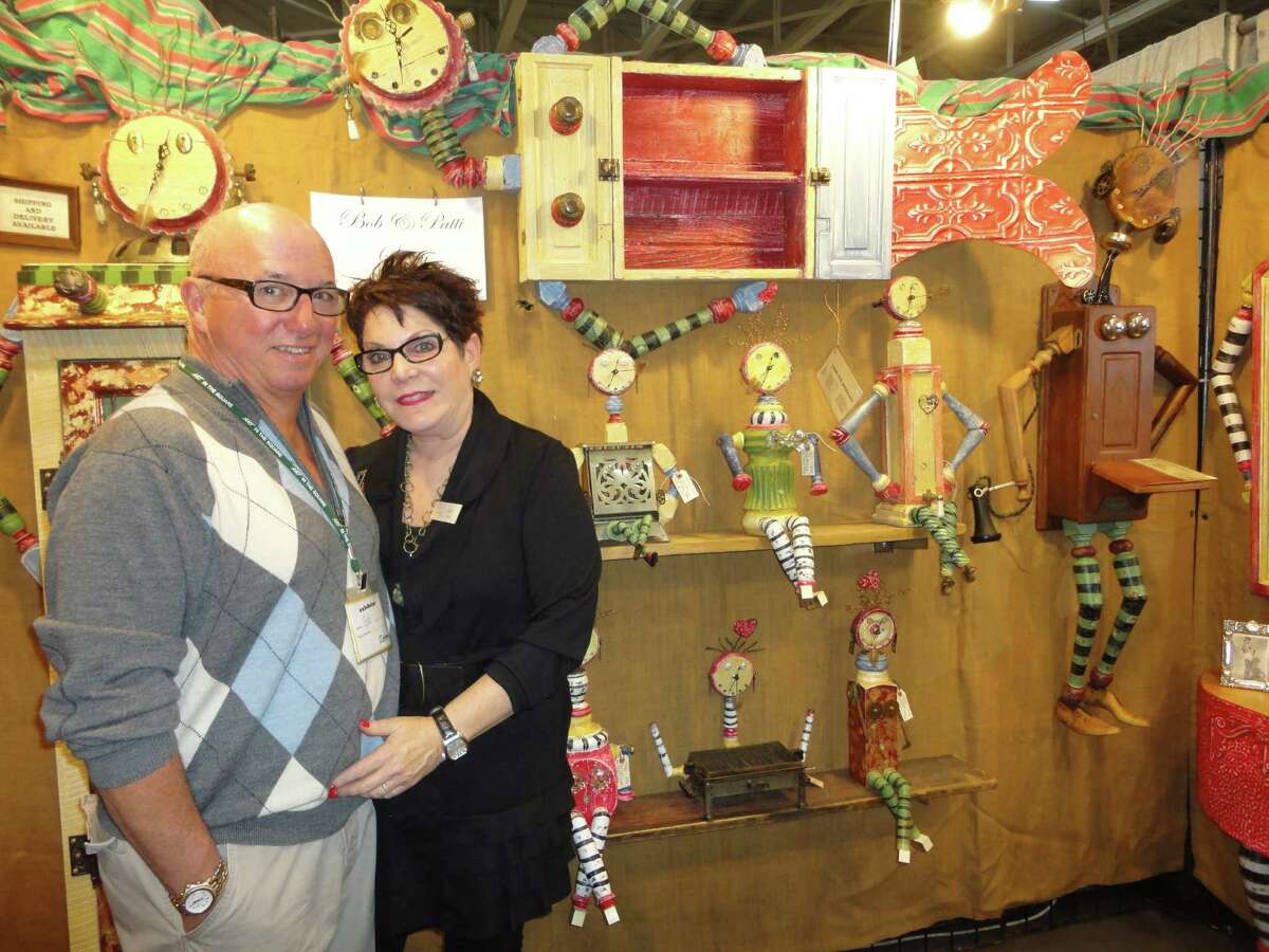 Mixed media artists Bob and Patti Stern of Cleveland, Ohio, pose in front of their whimsical creations Saturday at Staples High School, site of tghe 37th annual CraftWestport. The Sterns are almost the vendors who have appeared most often at CraftWestport. They were participating in their 15th such event. Westport Ct 11/17/12