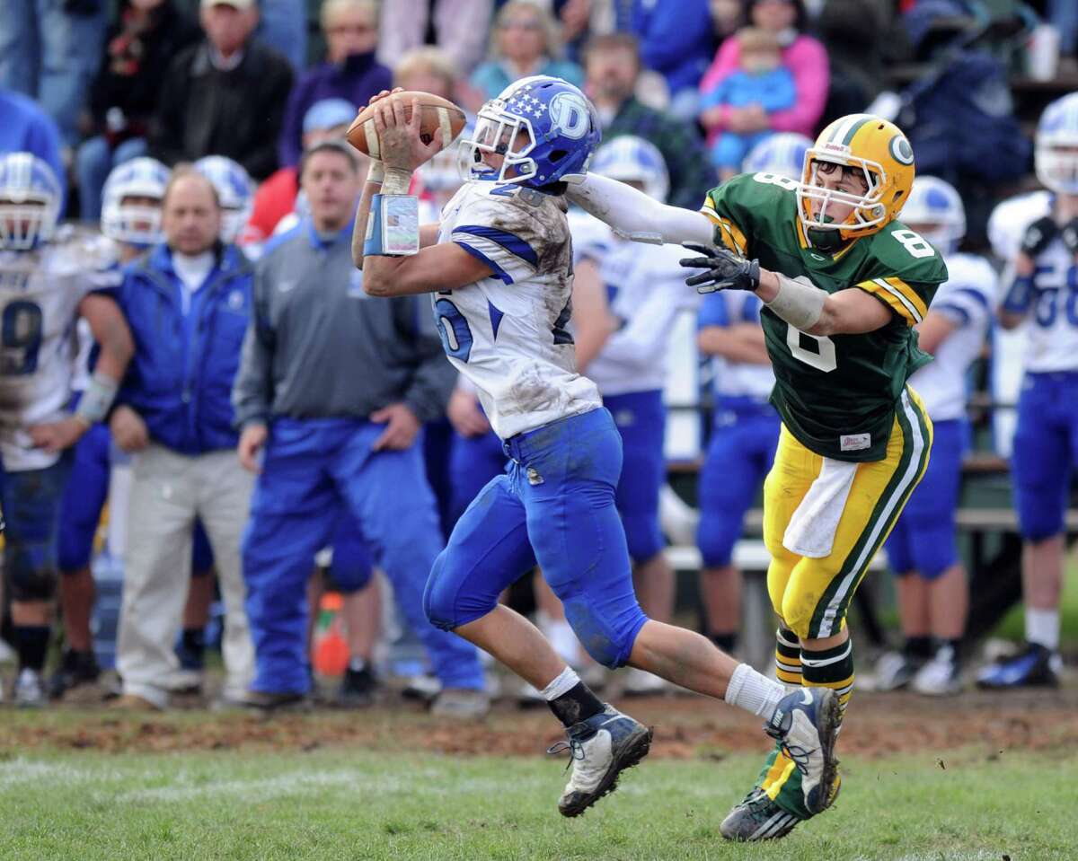 Darien's Peter Gesualdi intercepts a ball intended for Trinity Catholic's Connor Amann during Saturday's football game at Trinity Catholic High School on November 10, 2012.