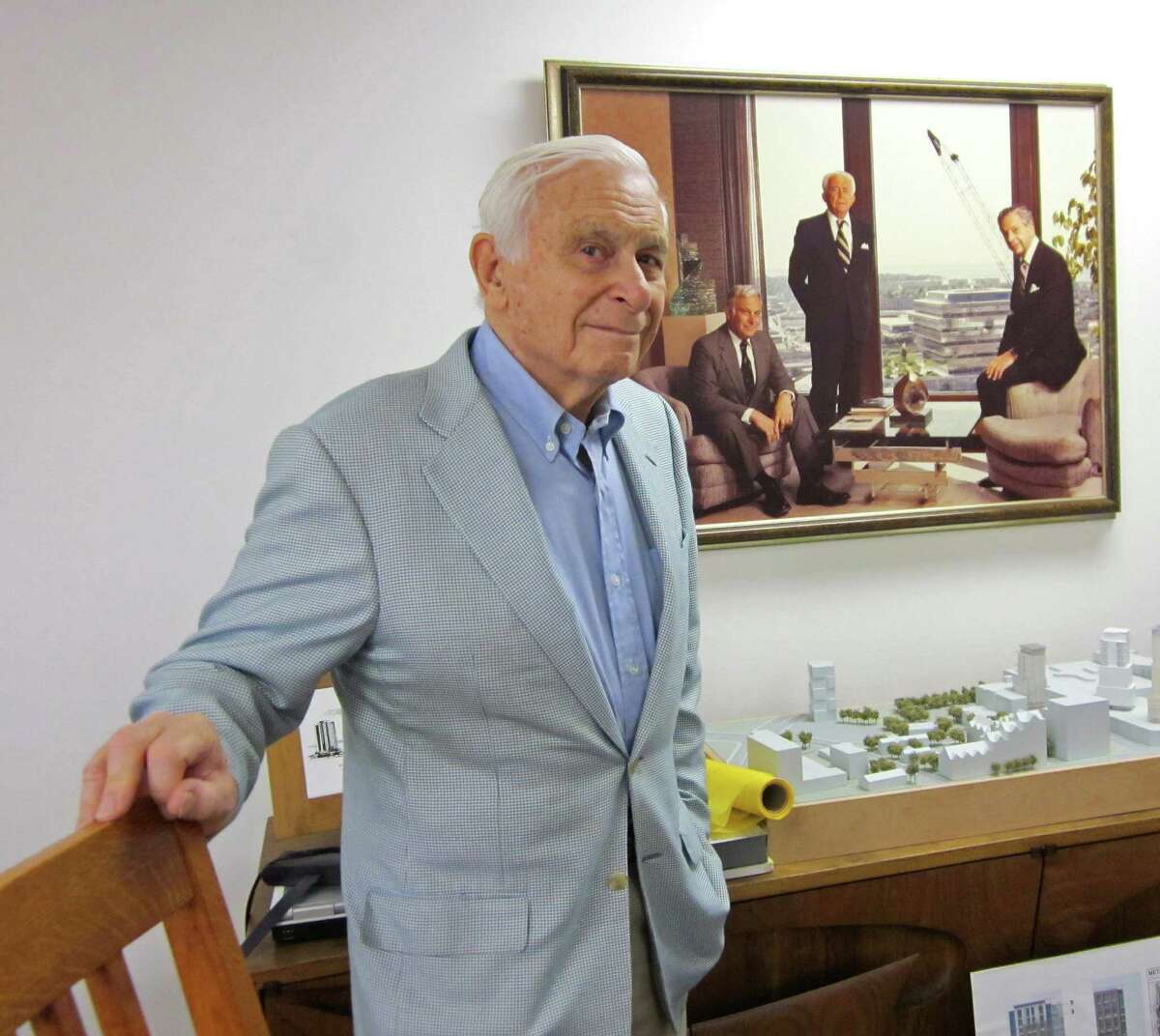 Robert N. Rich in his office on Summer Street in downtown Stamford in August 2012. Behind Rich is an image of him, on the left, with his father, F.D. Rich Sr., center, and brother F.D. Rich Jr. Robert N. Rich died Saturday, Nov. 17, 2012 at his Shippan Point home in Stamford at age 84 after a brief battle with leukemia.