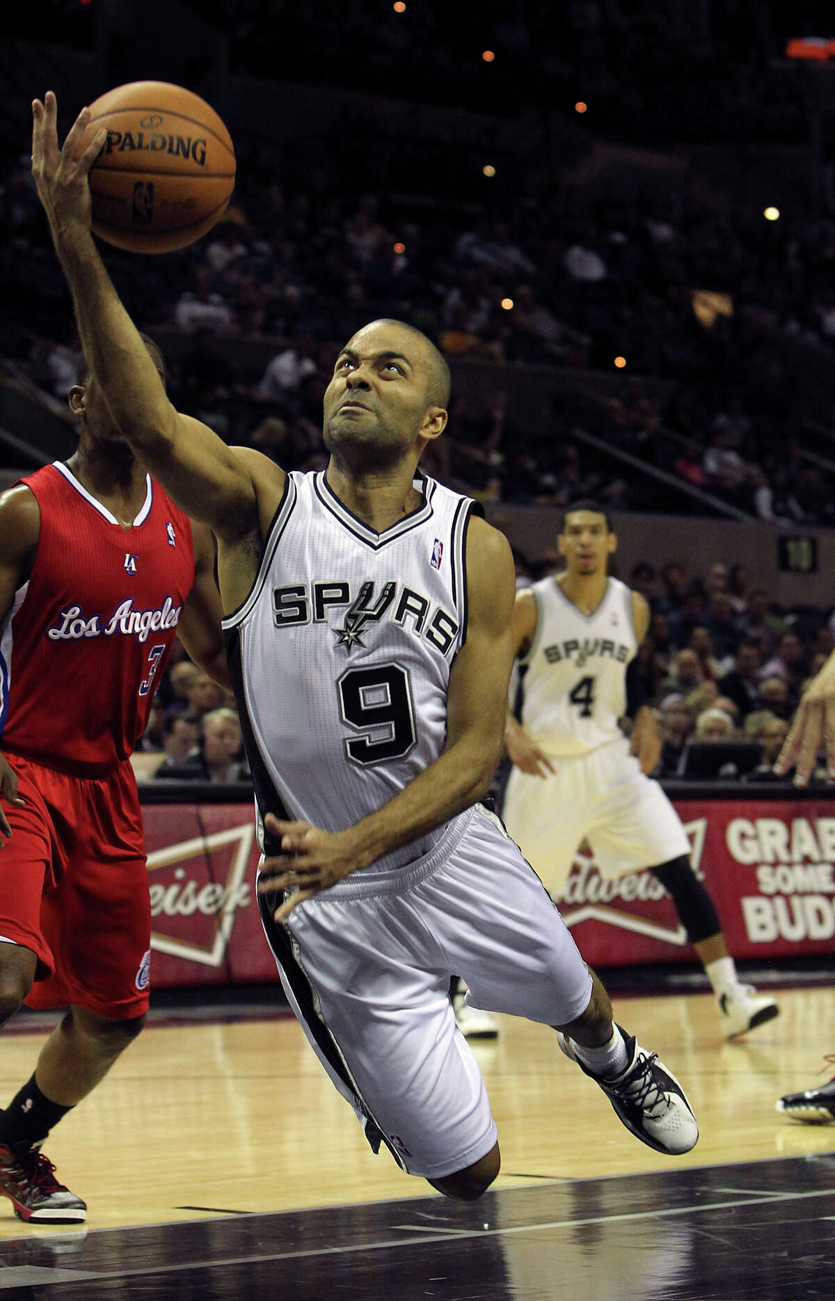 Spurs' Tony Parker spills toward the floor as he goes to make a shot against the Los Angeles Clippers in the first half of their game at the AT&T Center on Monday, Nov. 19, 2012.