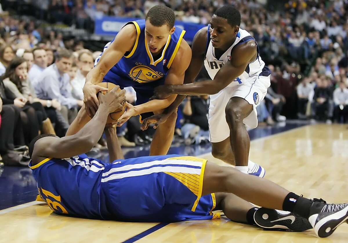 Dallas Mavericks point guard Darren Collison (4) battles Golden State Warriors shooting guard Stephen Curry (30) and center Festus Ezeli (31) for control of the ball during an NBA basketball game at the American Airlines Center in Dallas, Texas, Monday, November 19, 2012. (Brandon Wade/Fort Worth Star-Telegram/MCT)
