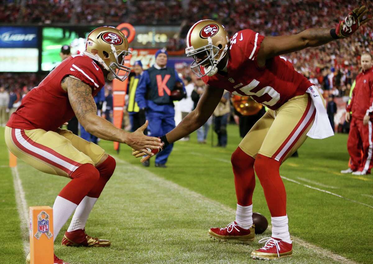 Niners QB Colin Kaepernick, left, and Michael Crabtree hooked up for a third-quarter touchdown pass.