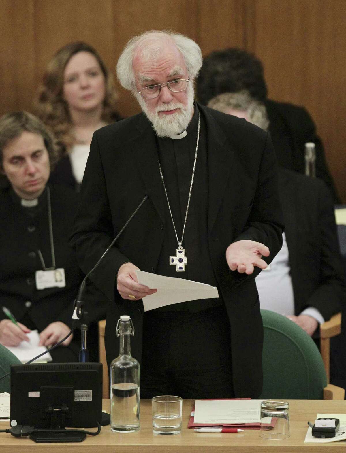 Dr Rowan Williams, centre, the outgoing Archbishop of Canterbury speaks during a meeting of the General Synod of the Church of England in central London, Tuesday, Nov. 20, 2012, - where a vote on whether to give final approval to legislation introducing the first women bishops will take place. The leader of the Church of England appealed for harmony among the faithful as it went into a vote Tuesday on whether to allow women to serve as bishops, a historic decision that comes after decades of debate. The push to muster a two-thirds majority among lay members of the General Synod is expected to be close, with many on both sides unsatisfied with a compromise proposal to accommodate individual parishes which spurn female bishops. (AP Photo/PA, Yui Mok, Pool)