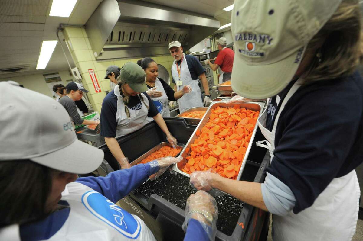 Volunteer chef Mark McDonald, center,oversees a group of volunteers prepping carrots for the Equinox Thanksgiving Dinner at the Empire State Plaza in Albany, NY Tuesday Nov. 20, 2012. (Michael P. Farrell/Times Union)