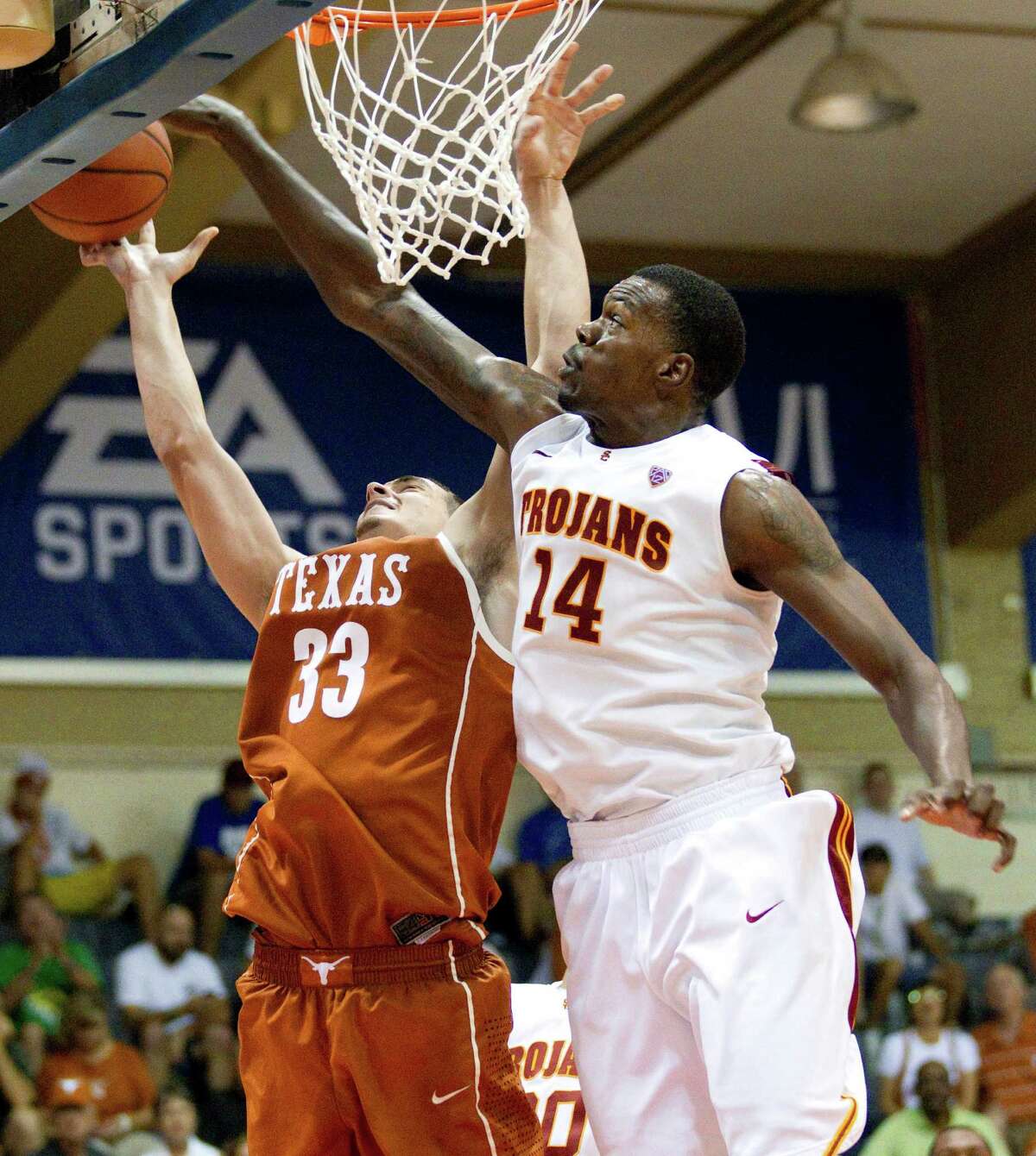 Texas forward Ioannis Papapetrou (33) goes for a layup as Southern California forward Dewayne Dedmon (14) deflects the shot in the second half of an NCAA college basketball game in the Maui Invitational on Tuesday, Nov. 20, 2012, in Lahaina, Hawaii. Southern California defeated Texas 59-53 in overtime. (AP Photo/Eugene Tanner)