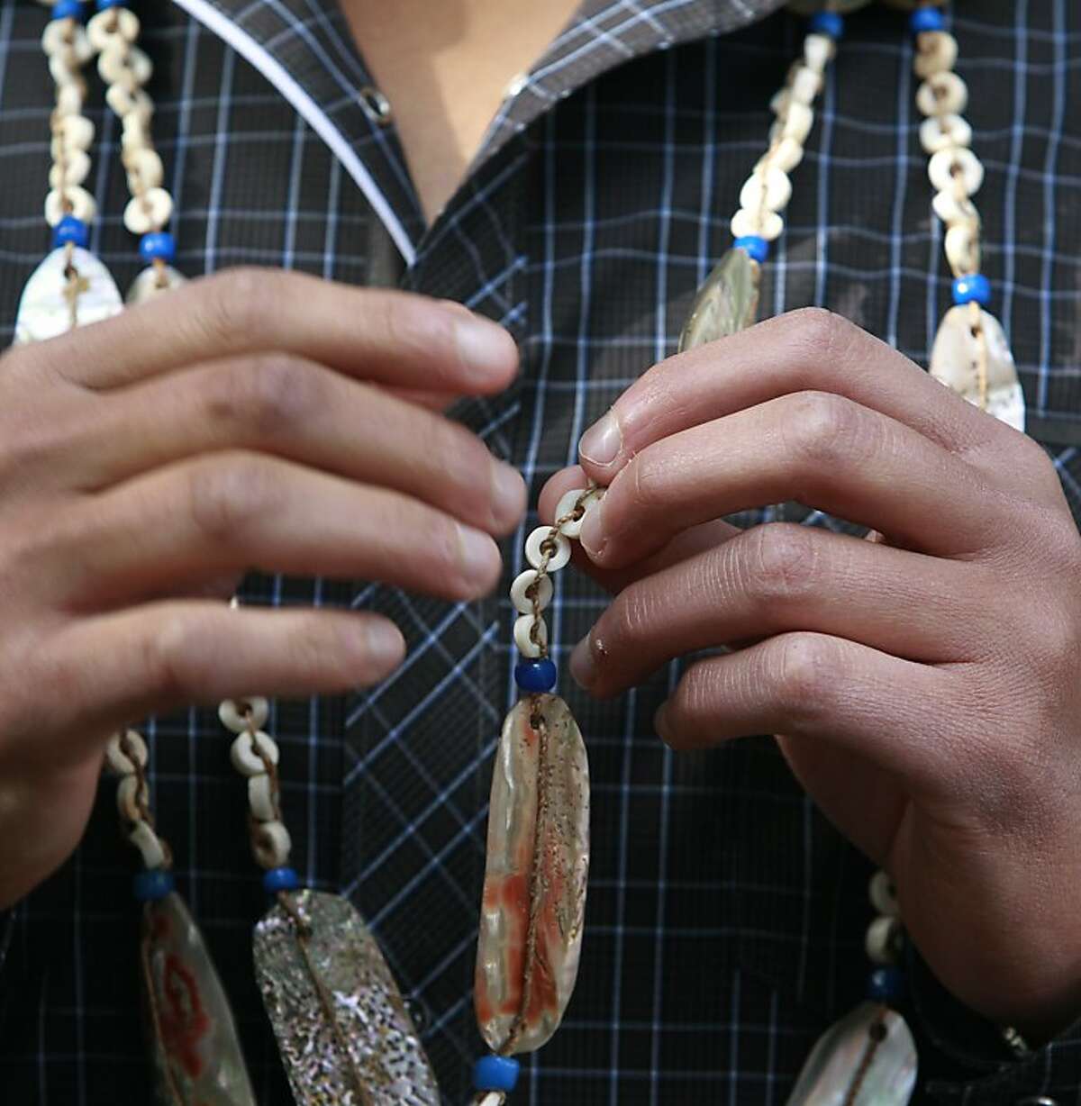 Vincent Medina wears a traditional necklace, handed down from Ohlone ancestors, while leading a tour of Mission Dolores for students from Oakland's Hillcrest Elementary School in San Francisco, Calif. on Thursday, Nov. 15, 2012. Medina is hoping to revive the Cochoenyo language that was spoken by his Ohlone ancestors.