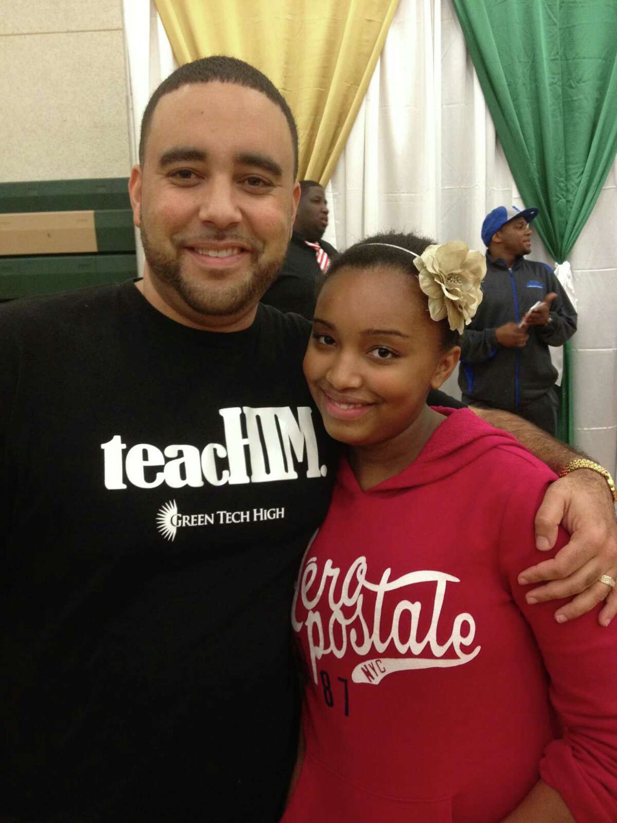 Green Tech High Charter School in Albany Principal Paul Miller and daughter Amaya Parsons-Miller help out at the community Thanksgiving-style dinner. (Submitted photo)