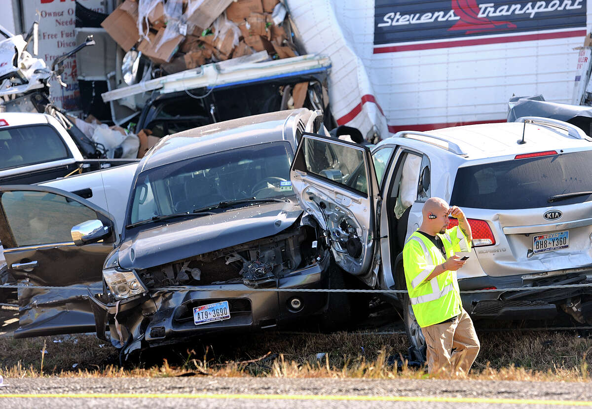 An emergency worker walks past a pile of cars from Thursday's accident on Interstate 10. Heavy fog and speeders are said to be the causes of the wreck that involved more than 100 cars. Several tractor trailers, a thanker truck and bus were also involved in the pile up. Photo taken Thursday, November 22, 2012 Guiseppe Barranco/The Enterprise
