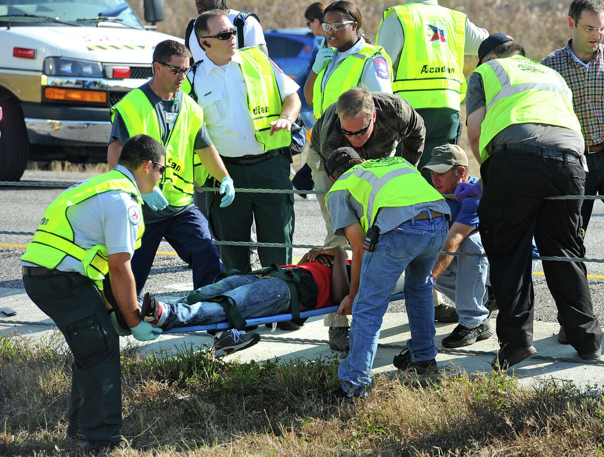 Emergency workers carry a victim across the Interstate 10 median after Thursday's massive auto accident. Heavy fog and speeders are said to be the causes of the wreck that involved more than 100 cars. Several tractor trailers, a thanker truck and bus were also involved in the pile up. Photo taken Thursday, November 22, 2012 Guiseppe Barranco/The Enterprise
