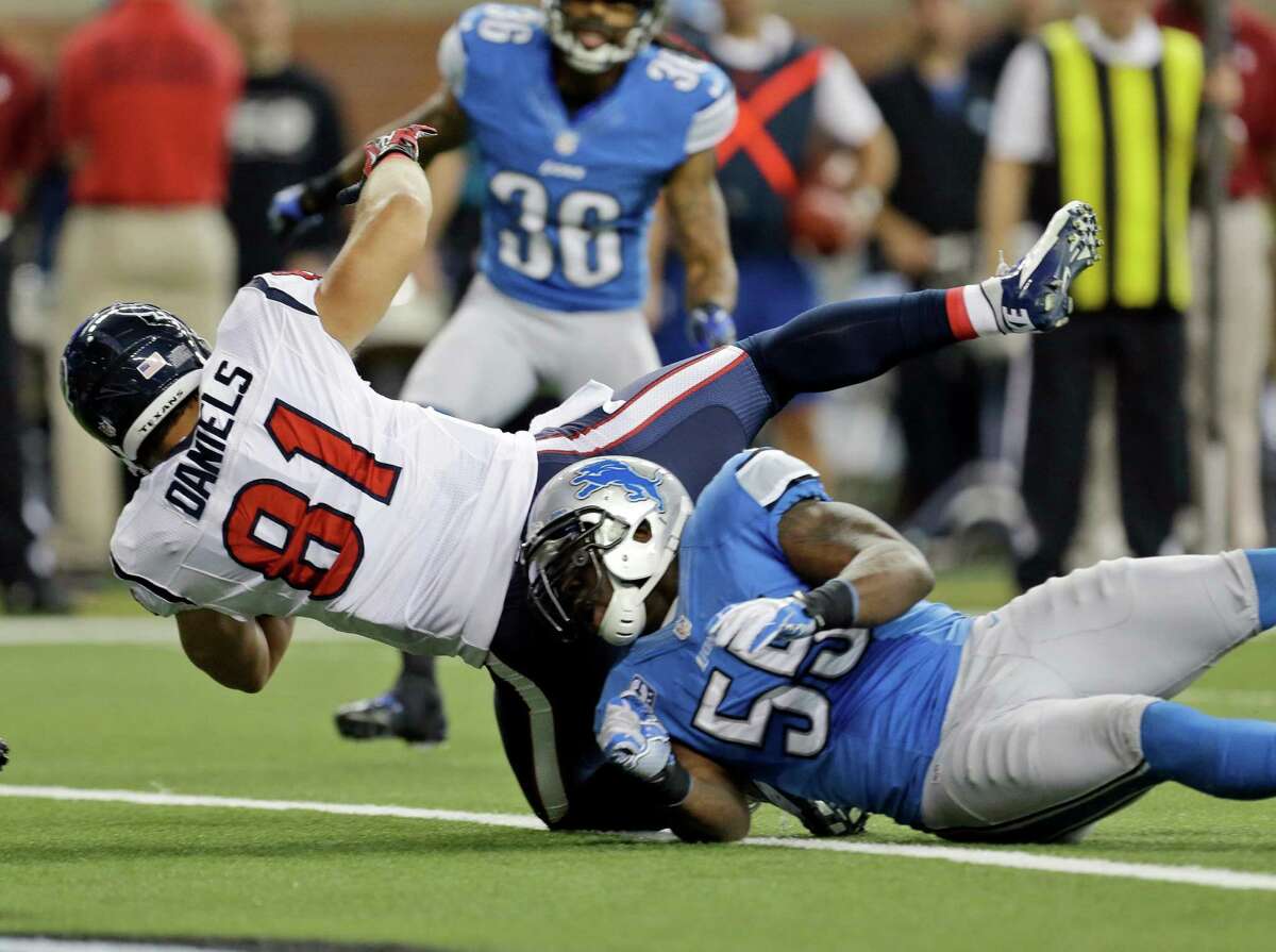 Houston Texans tight end Owen Daniels (81) falls into the end zone over Detroit Lions middle linebacker Stephen Tulloch (55) to score a touchdown during the second quarter of an NFL football game at Ford Field in Detroit, Thursday, Nov. 22, 2012. (AP Photo/Paul Sancya)
