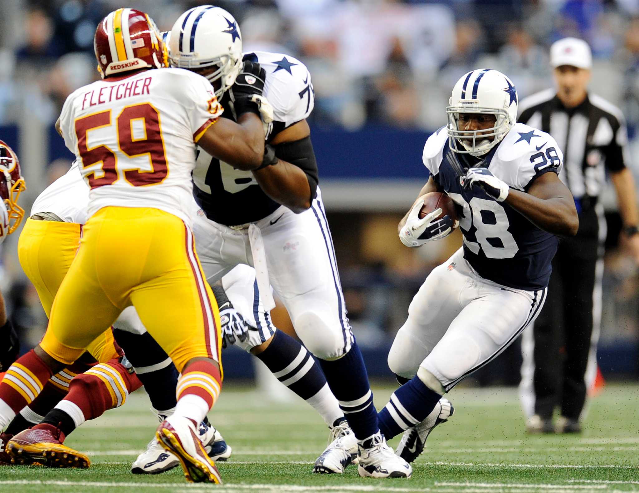 Dallas Cowboys wide receiver Dez Bryant (88) eludes Washington Redskins  defenders to take a Tony Romo pass for 85 yards and a touchdown in the  third quarter at Cowboys Stadium in Arlington