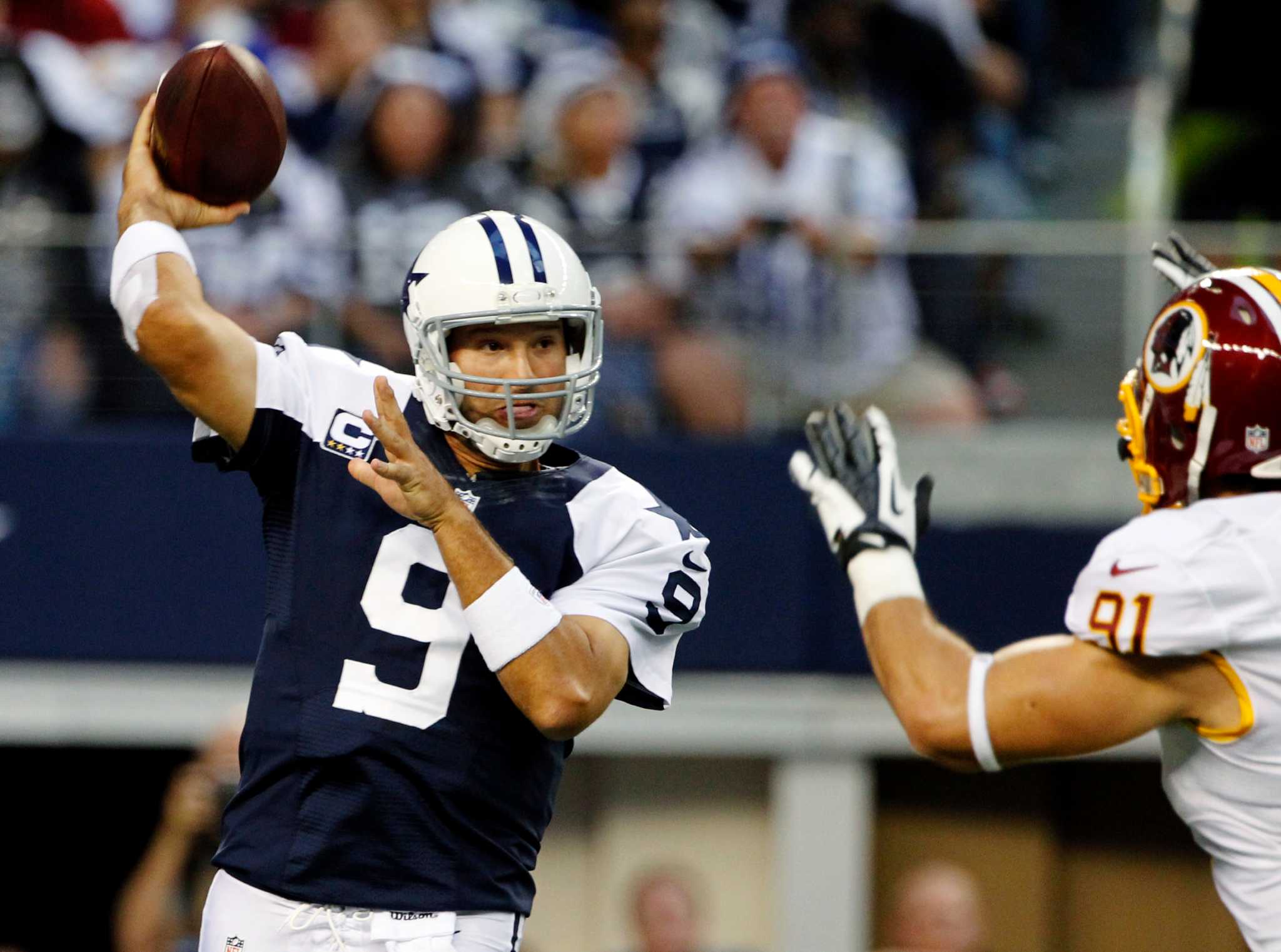 Dallas Cowboys wide receiver Dez Bryant (88) eludes Washington Redskins  defenders to take a Tony Romo pass for 85 yards and a touchdown in the  third quarter at Cowboys Stadium in Arlington