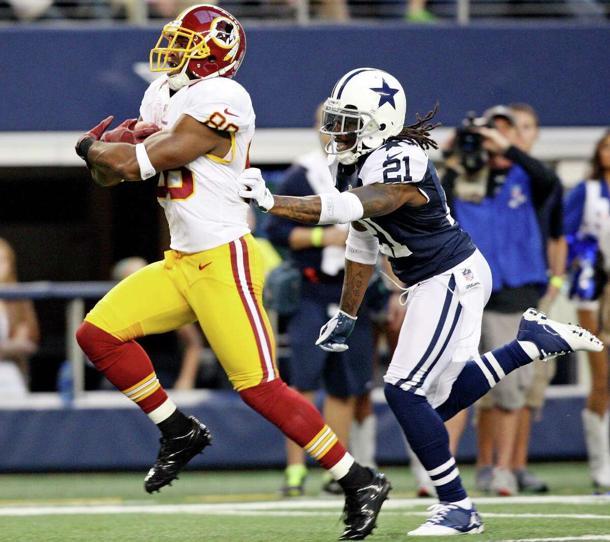 Washington Redskins' Pierre Gar�on heads to the end zone for a touchdown ahead of Dallas Cowboys' Mike Jenkins during first half action Thursday Nov. 22, 2012 at Cowboys Stadium in Arlington, Tx.