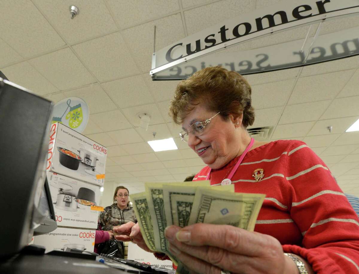 Eileen Kenna cashes out a customer Black Friday morning at JCPenney at Crossgates Mall in Guilderland. (Skip Dickstein / Times Union)