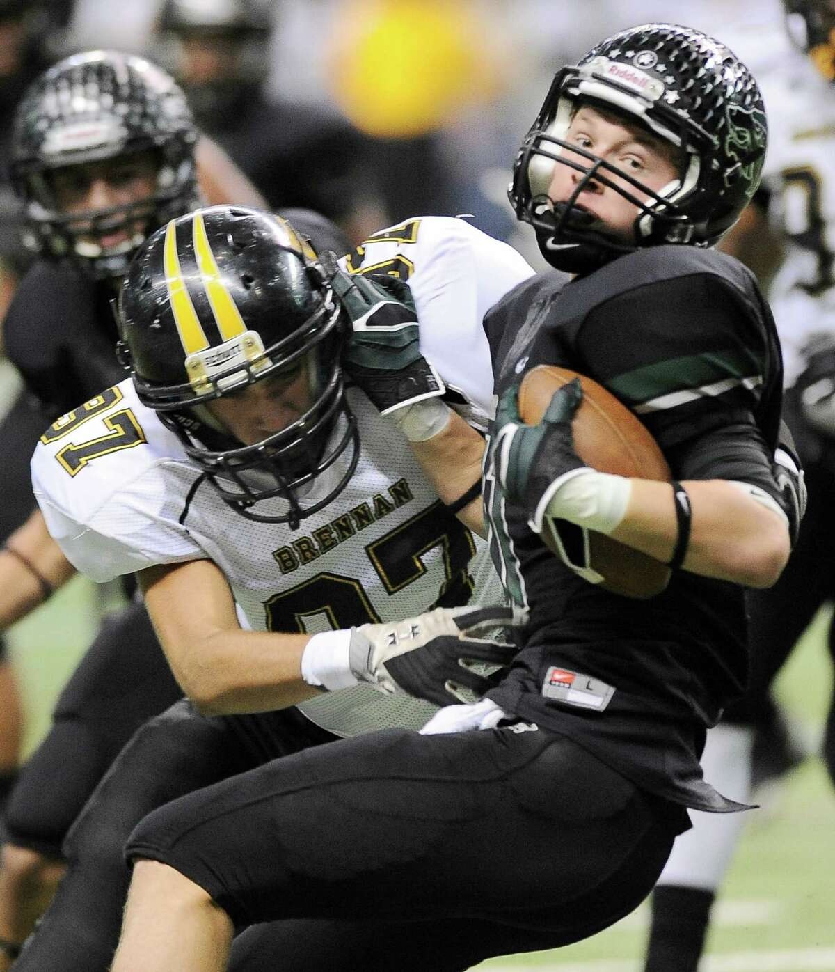 Brennan's James Hamilton, left, tackles Cedar Park's Lane Waller during the first half of a 4A high school football playoff game, Friday, Dec. 7, 2012, at the Alamodome in San Antonio.