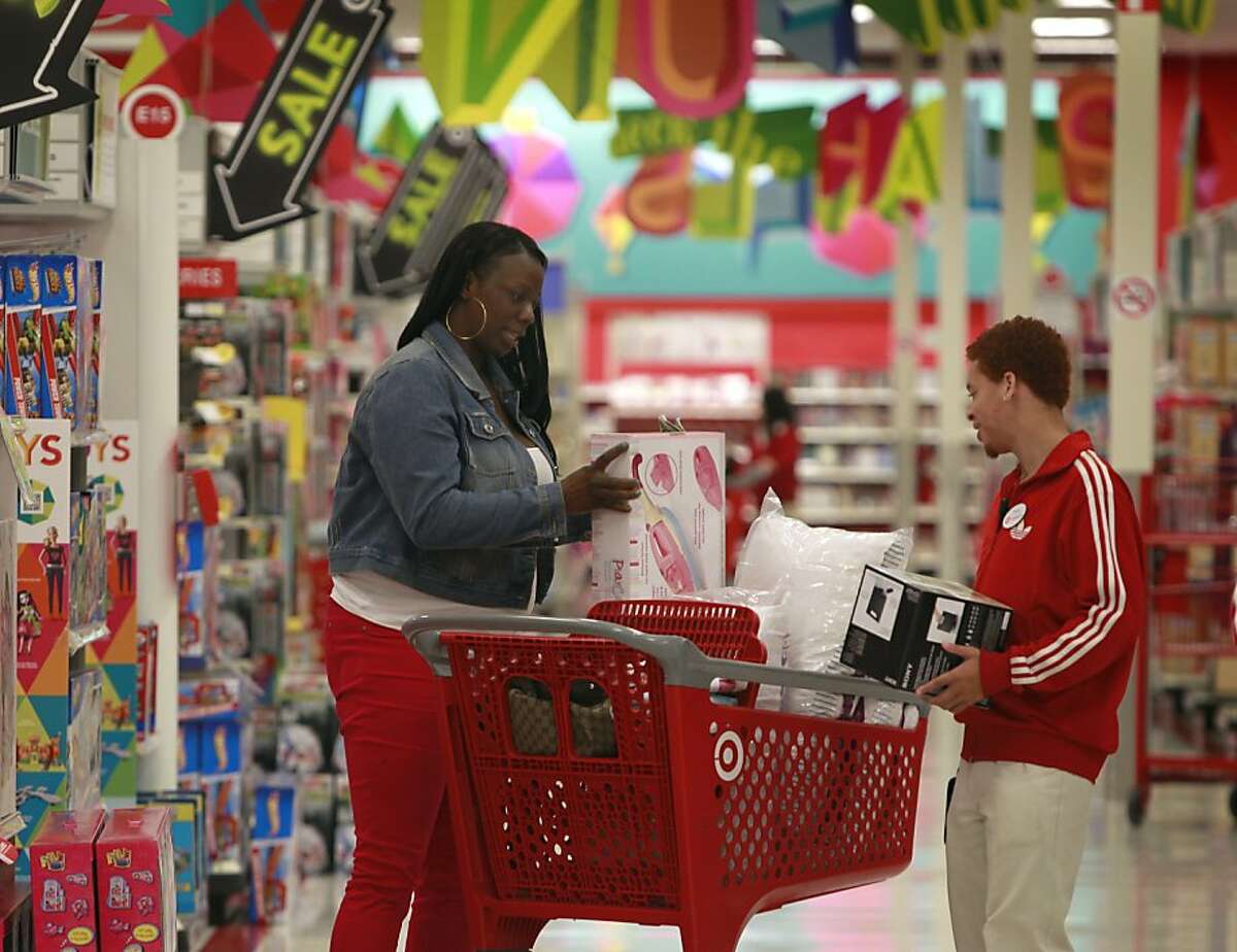 Taren Brewer (left) seeks assistance from salesman Tyrone Cherry during a break in the Black Friday shopping madness at Target in Emeryville, Calif. on Friday, Nov. 23, 2012. "This sale is out of this world. It's awesome," Brewer said.