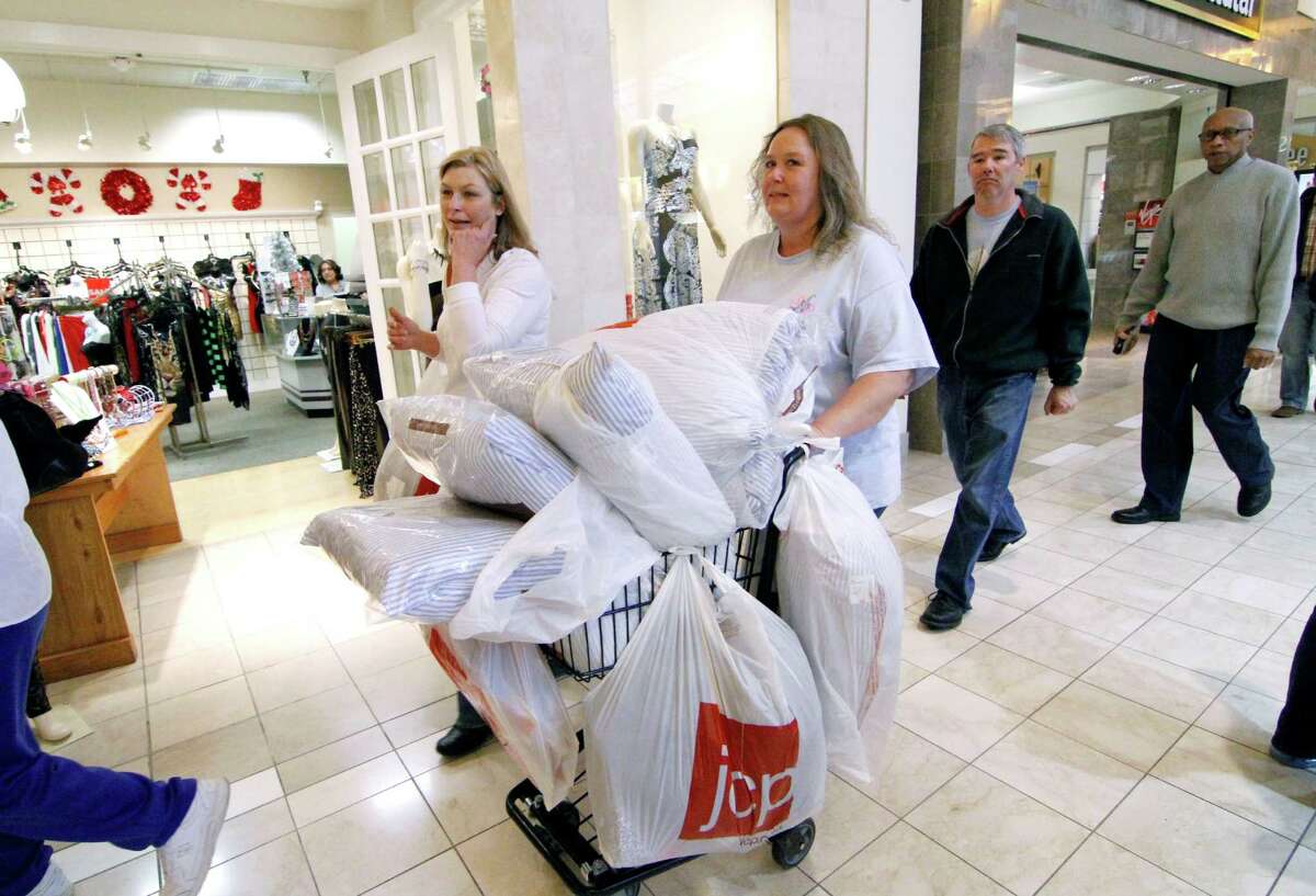 Laura Whitty of Harrisville, Miss., left, and Janice Barnett of Jayess, Miss. push a shopping cart through Northpark Mall in Ridgeland, Miss., Friday, Nov. 23, 2012. Black Friday, the day when retailers traditionally turn a profit for the year, got a jump start this year as many stores opened just as families were finishing up Thanksgiving dinner. (AP Photo/Rogelio V. Solis)