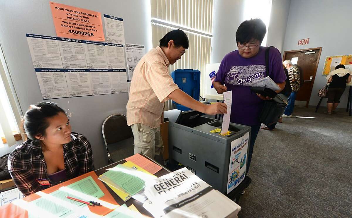 Election official Henry Tung (C) helps Kiyoko Nishi (R) drop her vote into the ballot box at a polling station at St. Paul's Lutheran Church in Monterey Park, Los Angeles County, on November 6, 2012 in California, as Americans flock to the polls nationwide to decide between President Barack Obama, his Rebuplican challenger Mitt Romney, and a wide range of other issues. Monterey Park is one of six cities in California's 49th Assembly District, the state's first legislative district where Asian-Americans make up the majority of the population. AFP PHOTO/Frederic J. BROWNFREDERIC J. BROWN/AFP/Getty Images