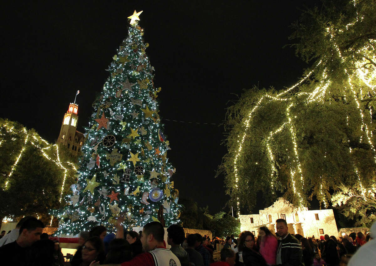 People gather at Alamo Plaza for the 28th Annual H-E-B Tree Lighting Ceremony on Friday, Nov. 23, 2012. The 55-foot tall fir tree was lit with 10,000 LED lights and with 450 ornaments. The event kicked off the holiday season followed by the 30th Annual Ford Holiday River Parade & Lighting Ceremony along the San Antonio River.