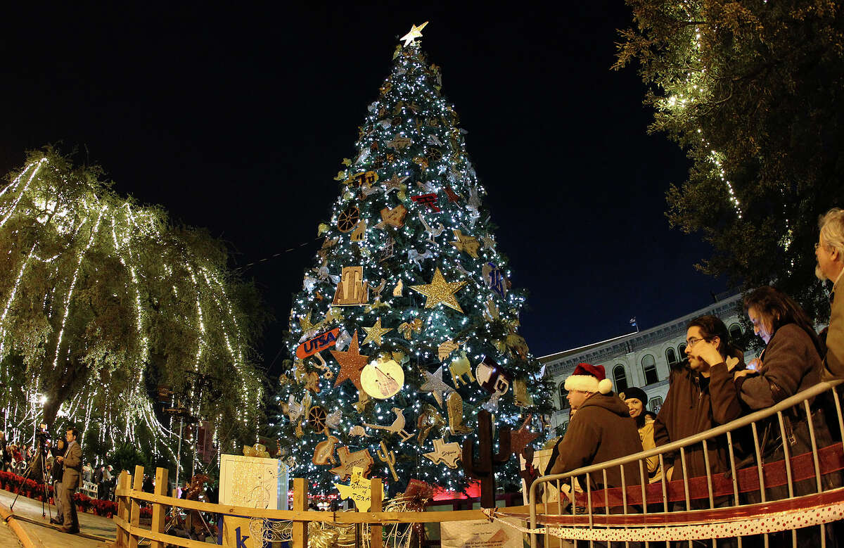 People gather at Alamo Plaza for the 28th Annual H-E-B Tree Lighting Ceremony on Friday, Nov. 23, 2012. The 55-foot tall fir tree was lit with 10,000 LED lights and with 450 ornaments. The event kicked off the holiday season followed by the 30th Annual Ford Holiday River Parade & Lighting Ceremony along the San Antonio River.