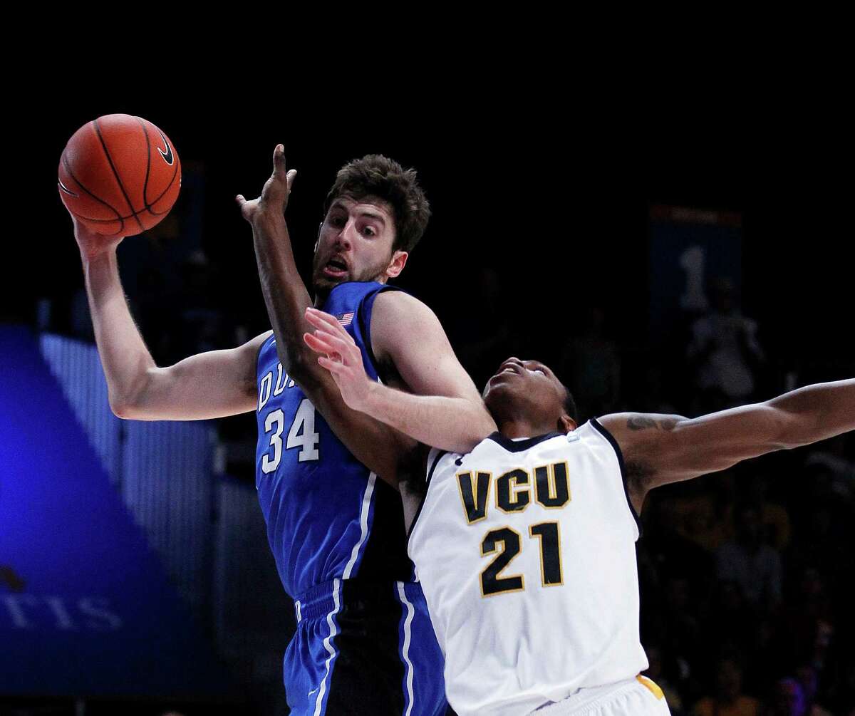 Duke forward Ryan Kelly (34) and Virginia Commonwealth guard Treveon Graham (21) fight for a rebound in the first half of an NCAA college basketball game at the Battle 4 Atlantis tournament on Friday, Nov. 23, 2012, in Paradise Island, Bahamas. (AP Photo/John Bazemore)