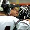 Burnt Hills' coach Matt Shell, center, embraces his players as the clock winds down in their Class A football state final against Sweet Home on Friday, Nov. 23, 2012, at the Carrier Dome in Syracuse, N.Y. (Cindy Schultz / Times Union)