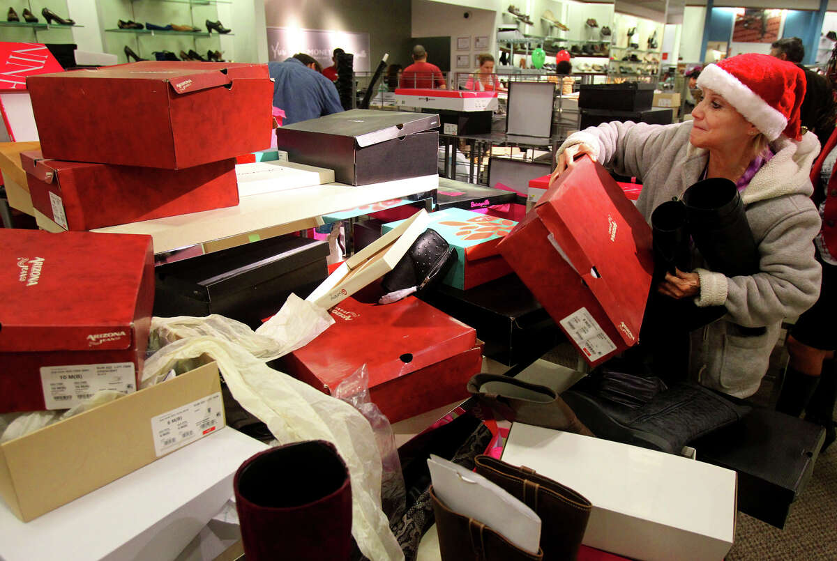 Rose Pena (right) sifts through a pile of shoe boxes looking for a boot that matches the one she was hoping to purchase at JC Penny at North Star Mall Black Friday November 23, 2012. Pena and other shoppers at the mall were taking advantage of Black Friday sales.