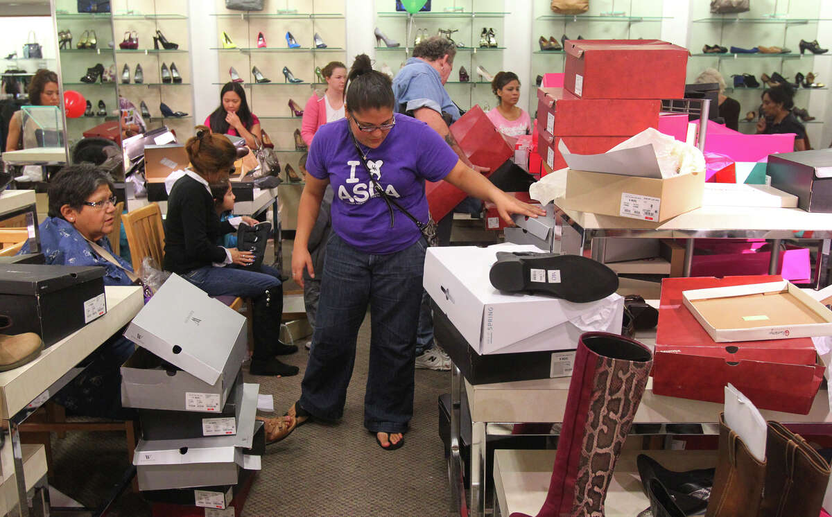 Raulene Flores (center) sifts through a pile of shoe boxes looking for some boots for her mother at JC Penny at North Star Mall Black Friday November 23, 2012. Flores and other shoppers at the mall were taking advantage of Black Friday sales.
