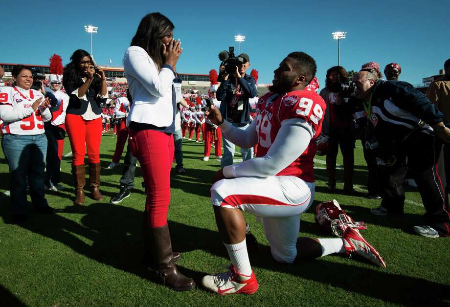During a milestone momentPictured:Houston defensive lineman Dominic Miller (99) kneels at midfield as he proposes to his girlfriend Chelsea Johnson before a college football game against Tulane at Robertson Stadium, Saturday, Nov. 24, 2012, in Houston. Johnson accepted the marriage proposal, which came during senior day festivities. Photo: Smiley N. Pool, Houston Chronicle / © 2012 Houston Chronicle