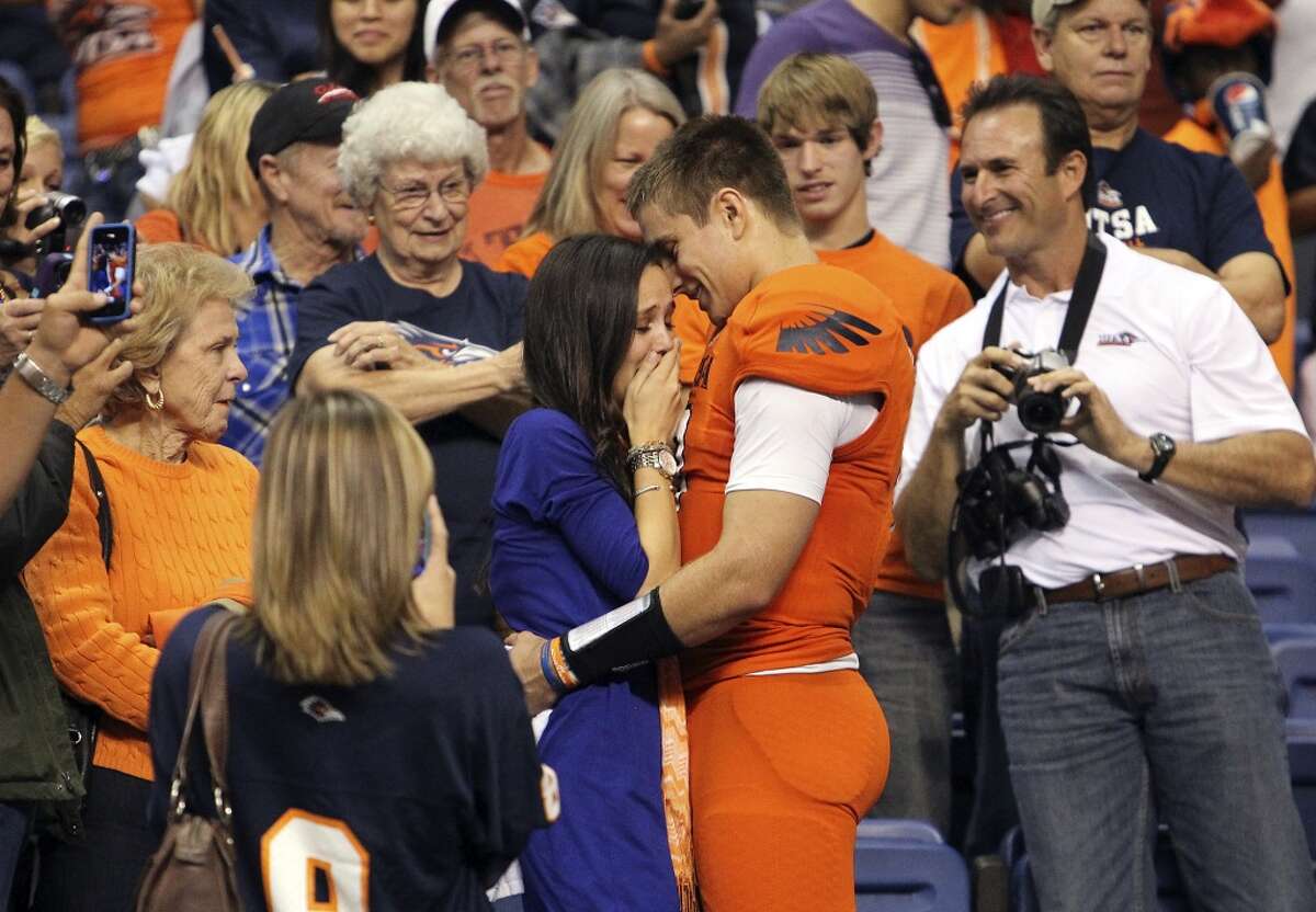 UTSA quarterback Eric Soza (right) proposes to his girlfriend Audrey Jones after the game against Texas State at the Alamodome on Saturday, Nov. 24, 2012. The Roadrunners defeated the Bobcats 38-31. Jones accepted according to family friends. (Kin Man Hui / San Antonio Express-News)